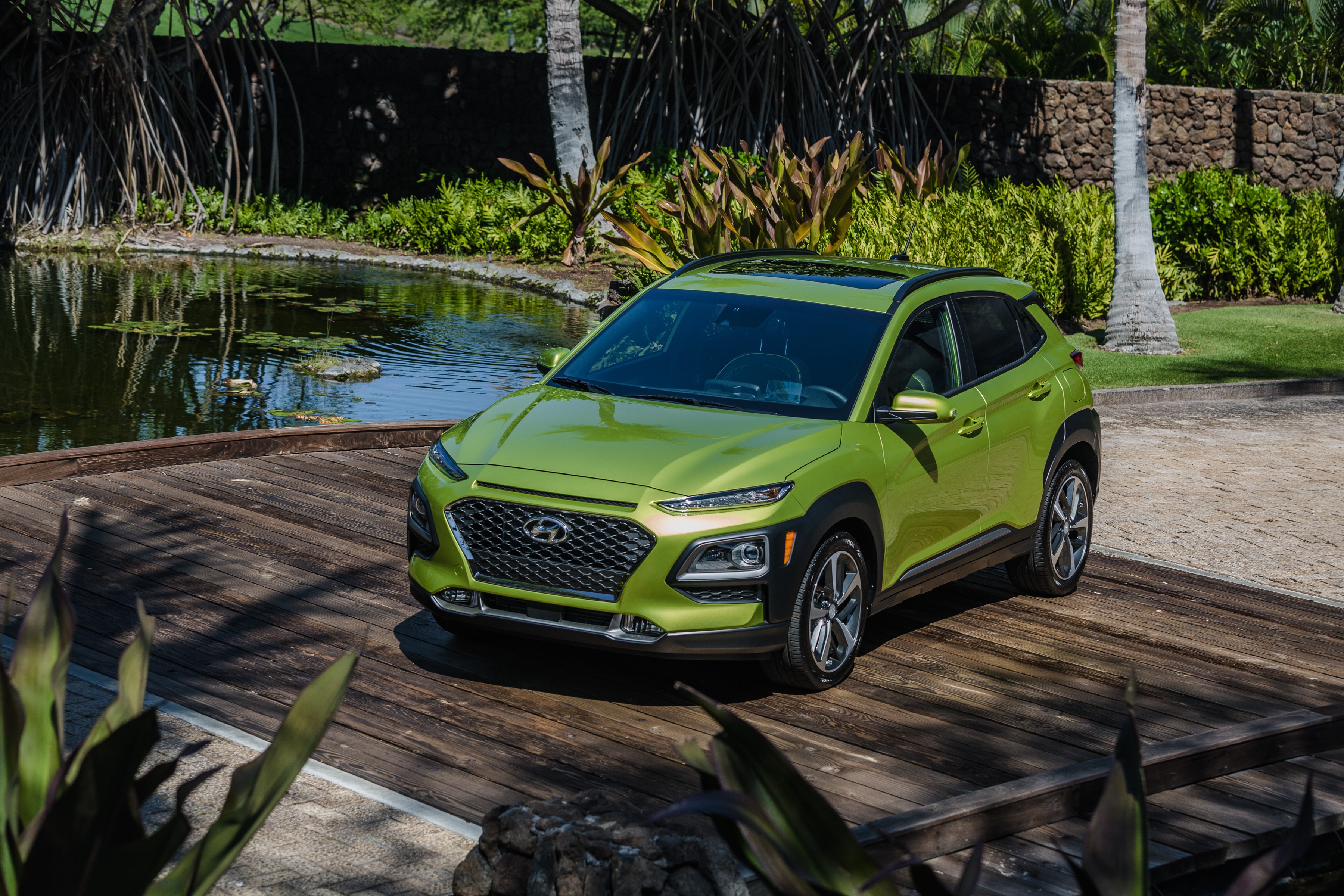 Green Hyundai Kona on a wooden deck HD Wallpaper