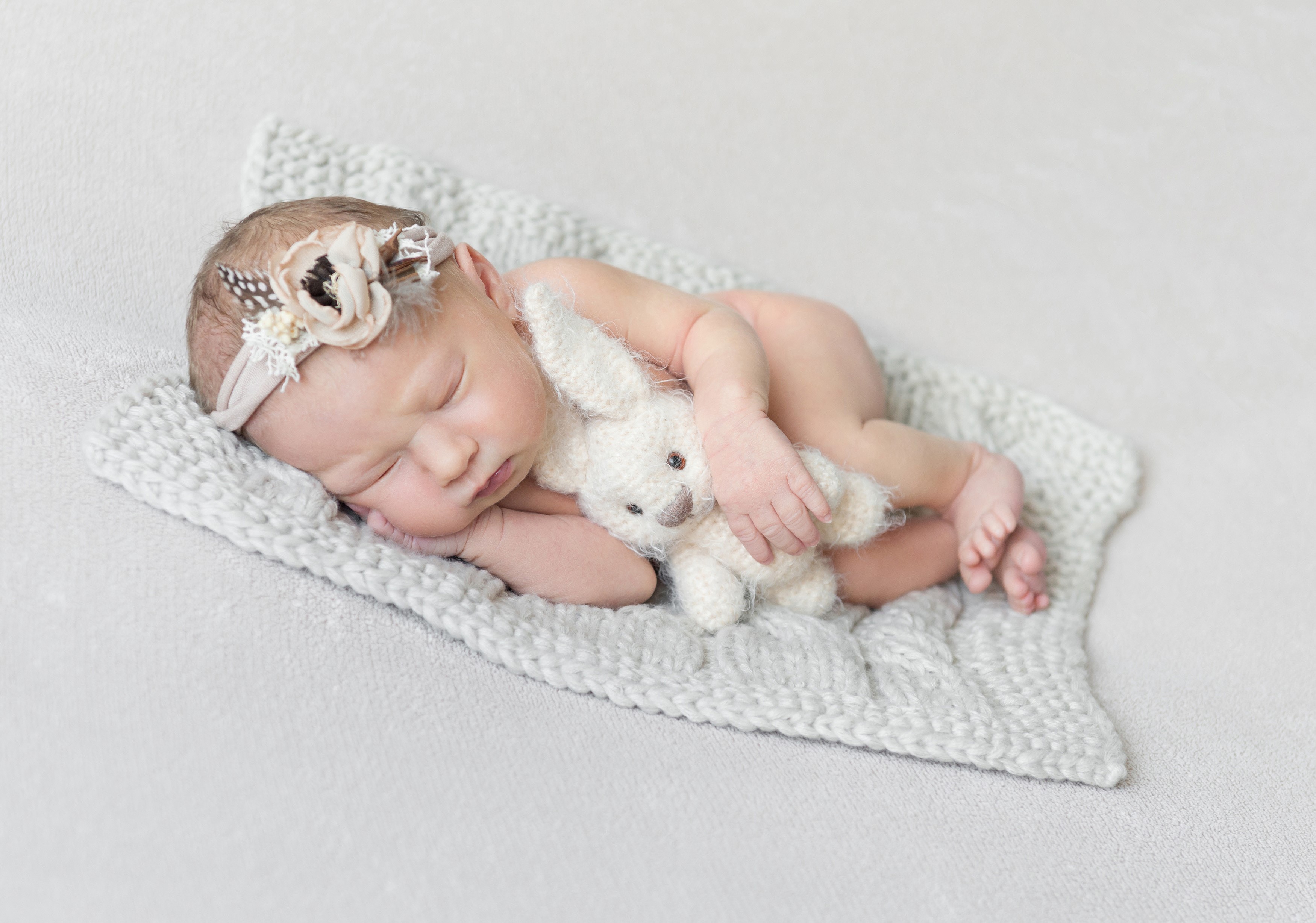 Newborn baby sleeping with a stuffed bunny HD Wallpaper