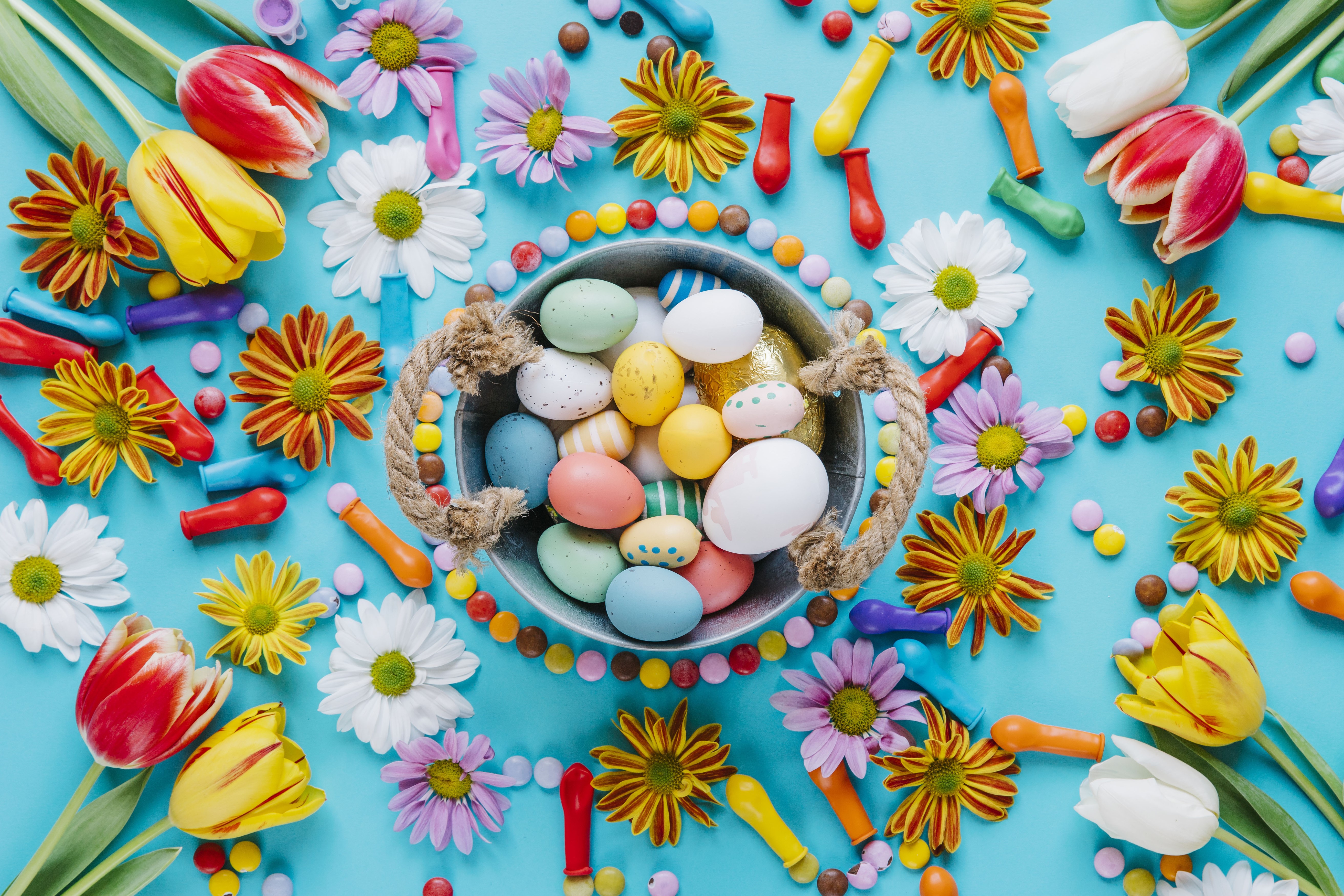 Easter eggs, tulips, and chrysanthemums with candy HD Wallpaper