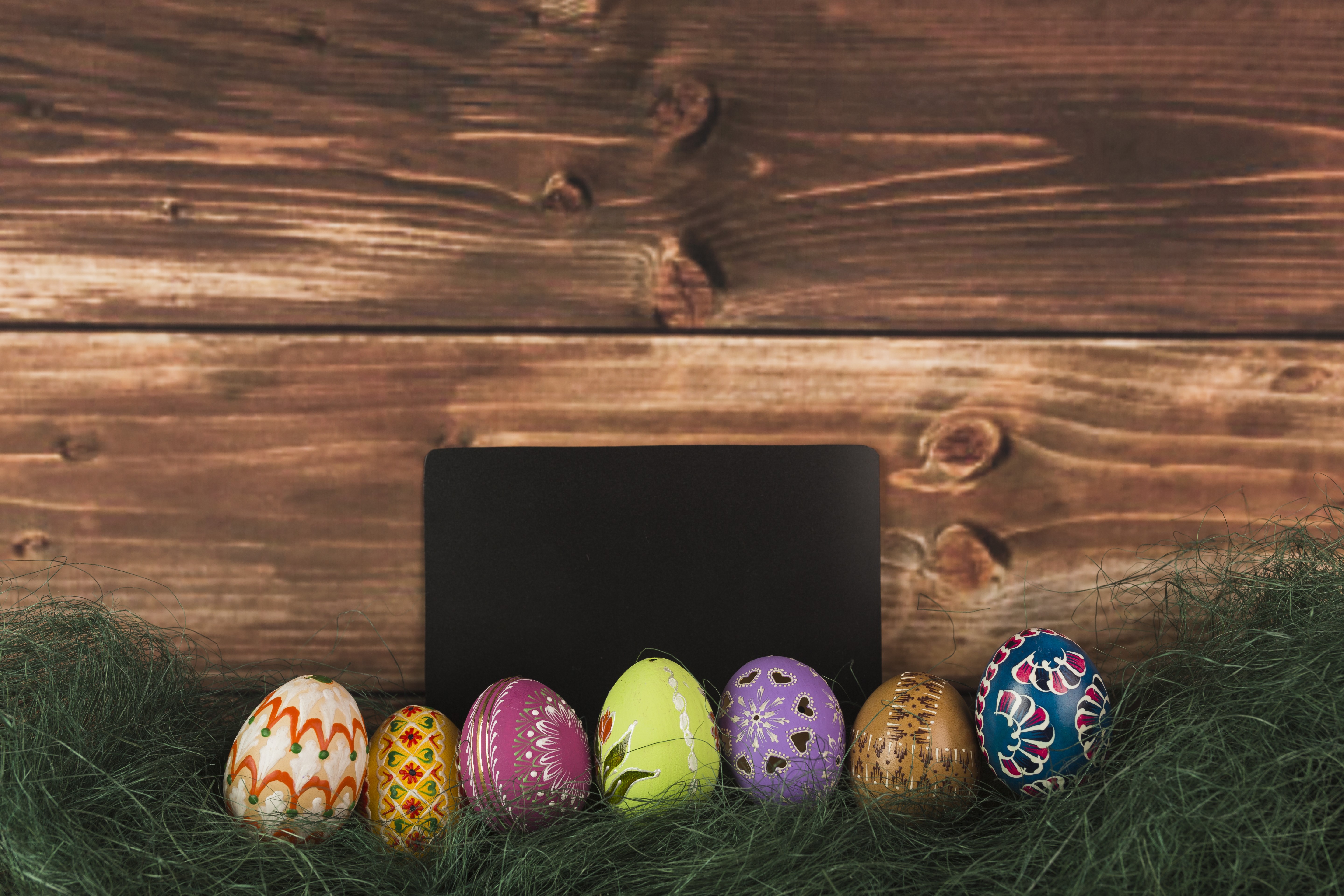 Easter Eggs on Grass with Wooden Background and Chalkboard HD Wallpaper