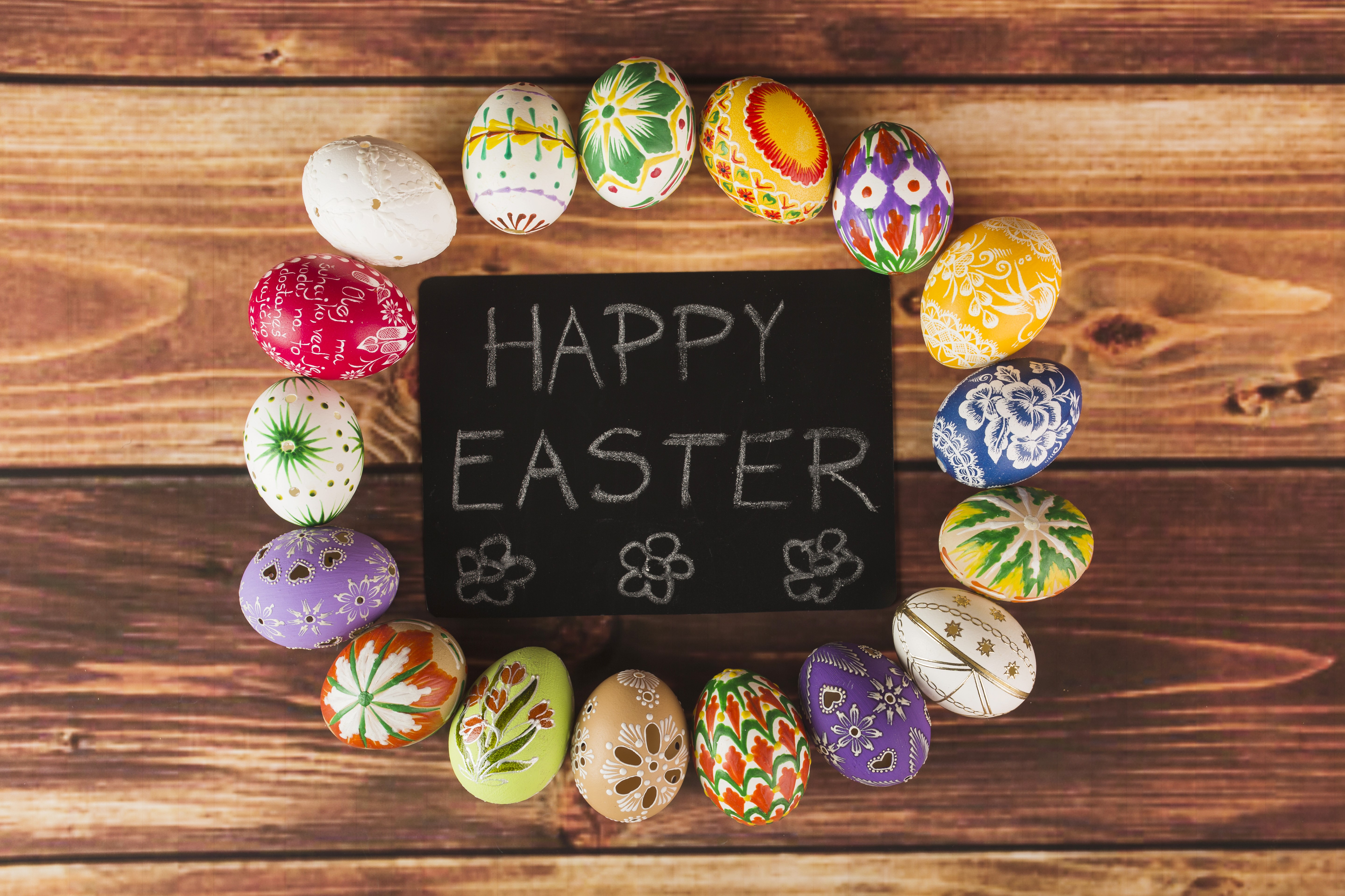 Easter eggs arranged around a chalkboard with Happy Easter message HD Wallpaper