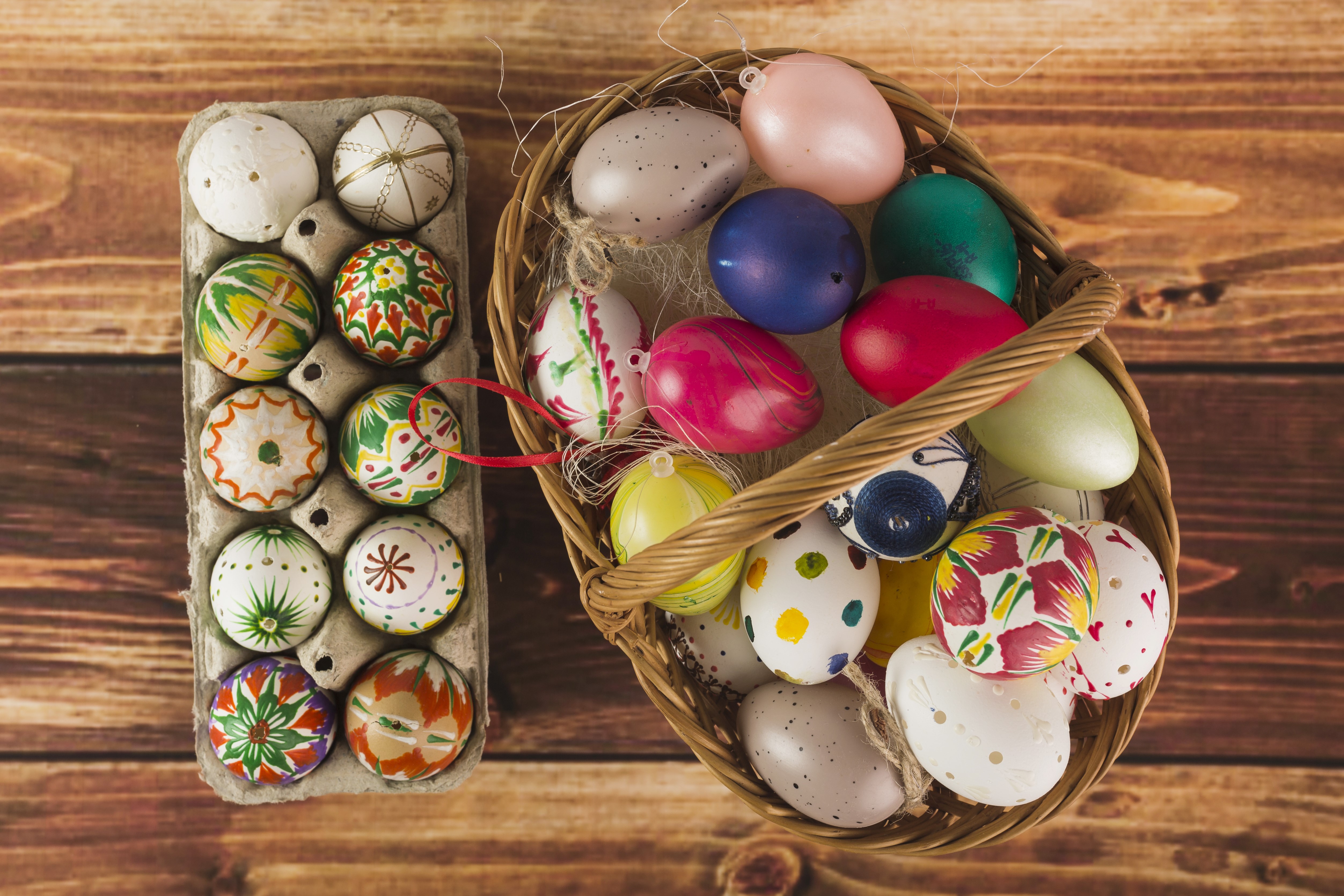 Easter eggs in a basket and carton on wood HD Wallpaper