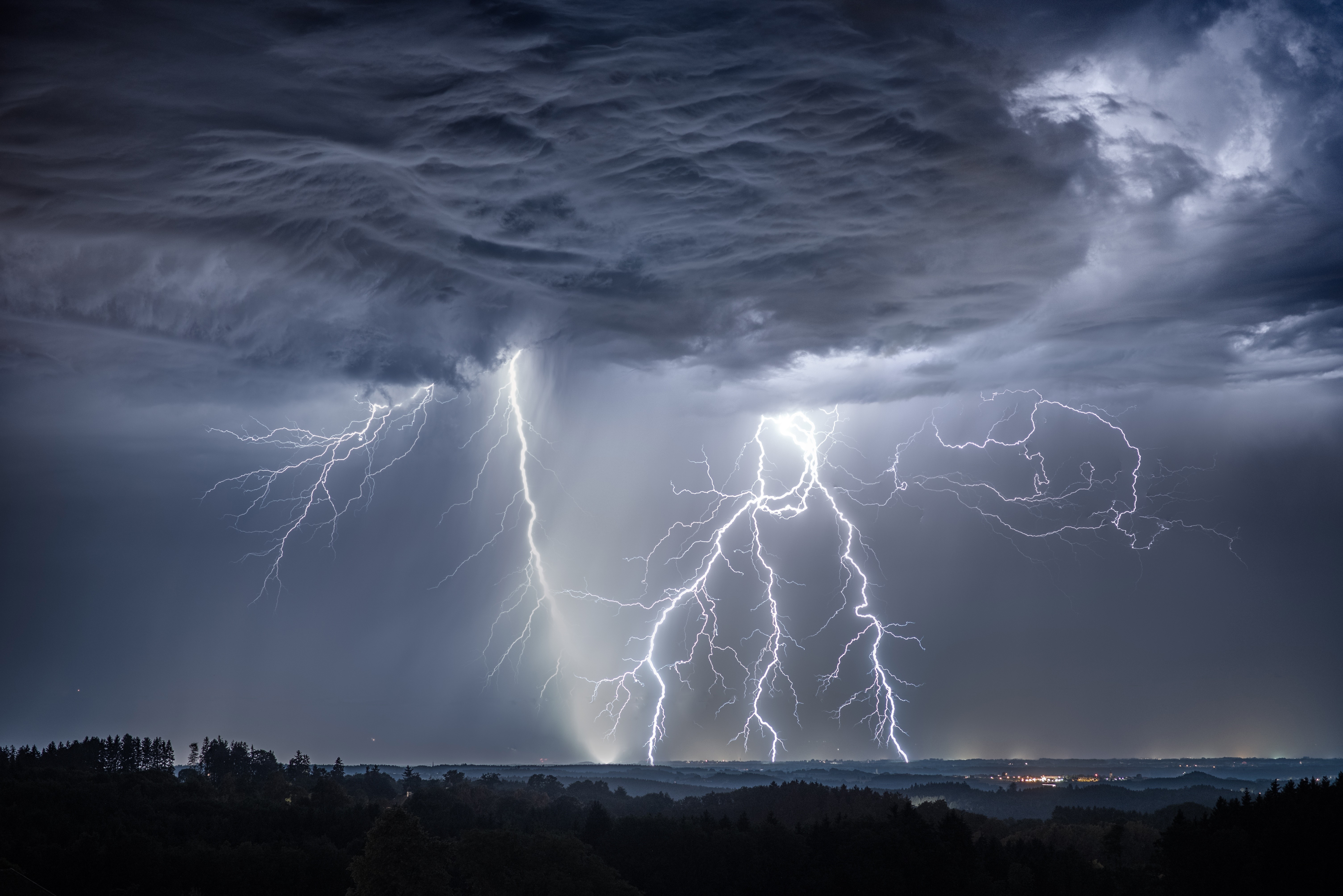 Lightning strikes through thunderclouds over a landscape HD Wallpaper