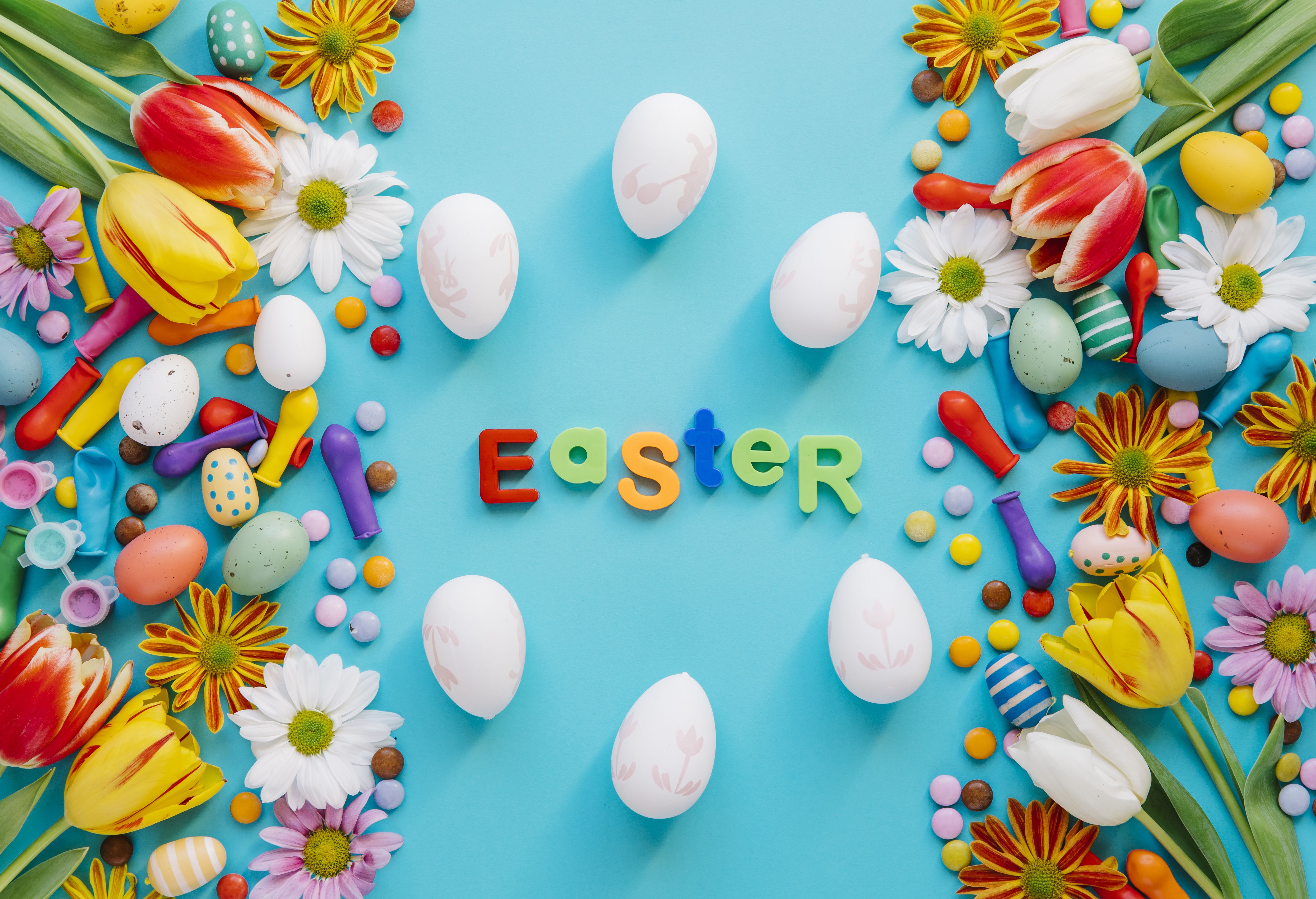 Easter decoration with tulips, eggs, and candies HD Wallpaper