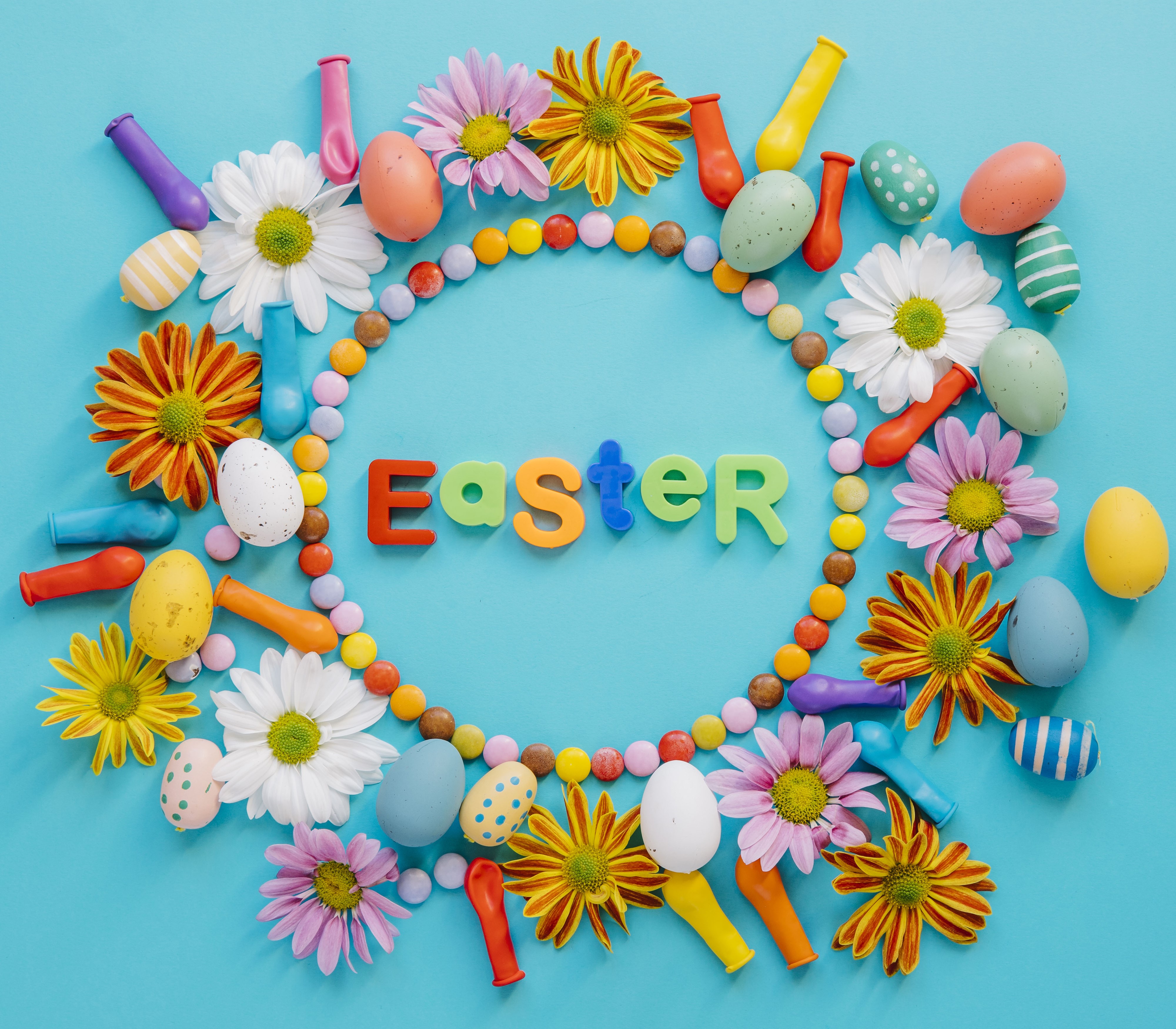 Easter decoration with eggs, flowers, and candy HD Wallpaper