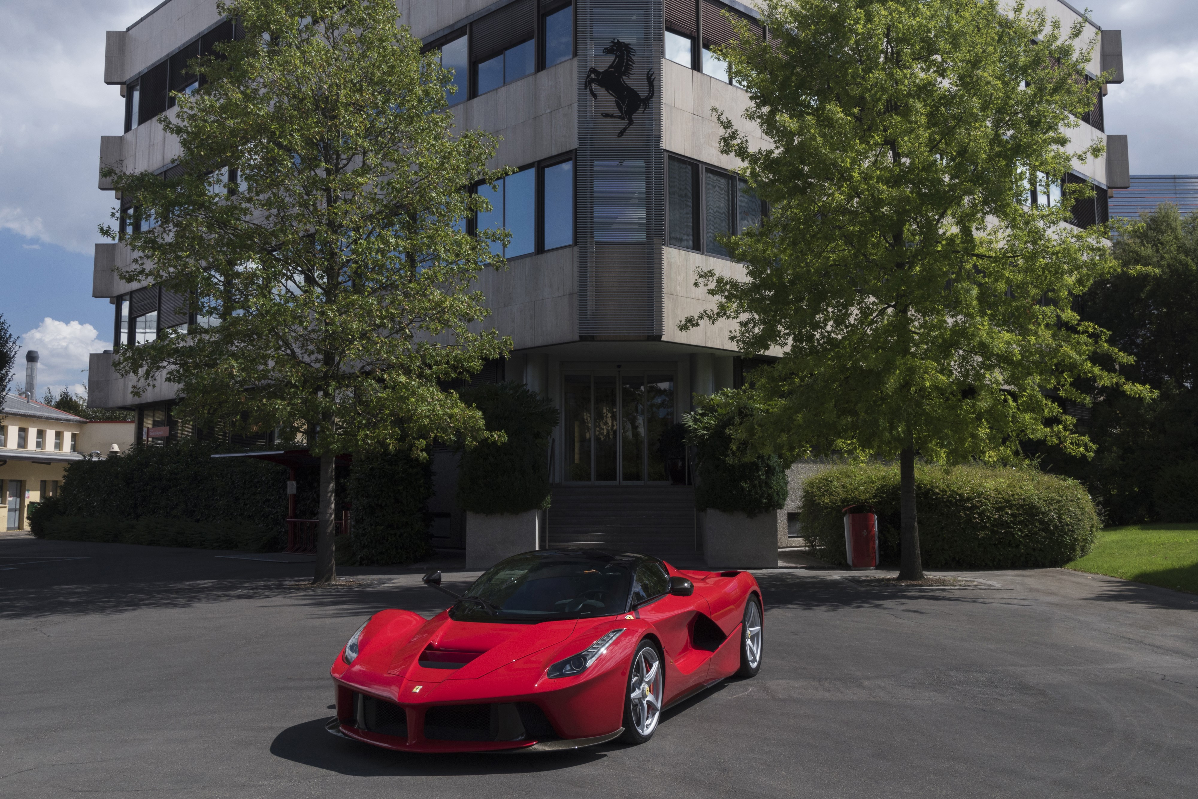 Red Ferrari LaFerrari Prototipo in front of Ferrari building HD Wallpaper