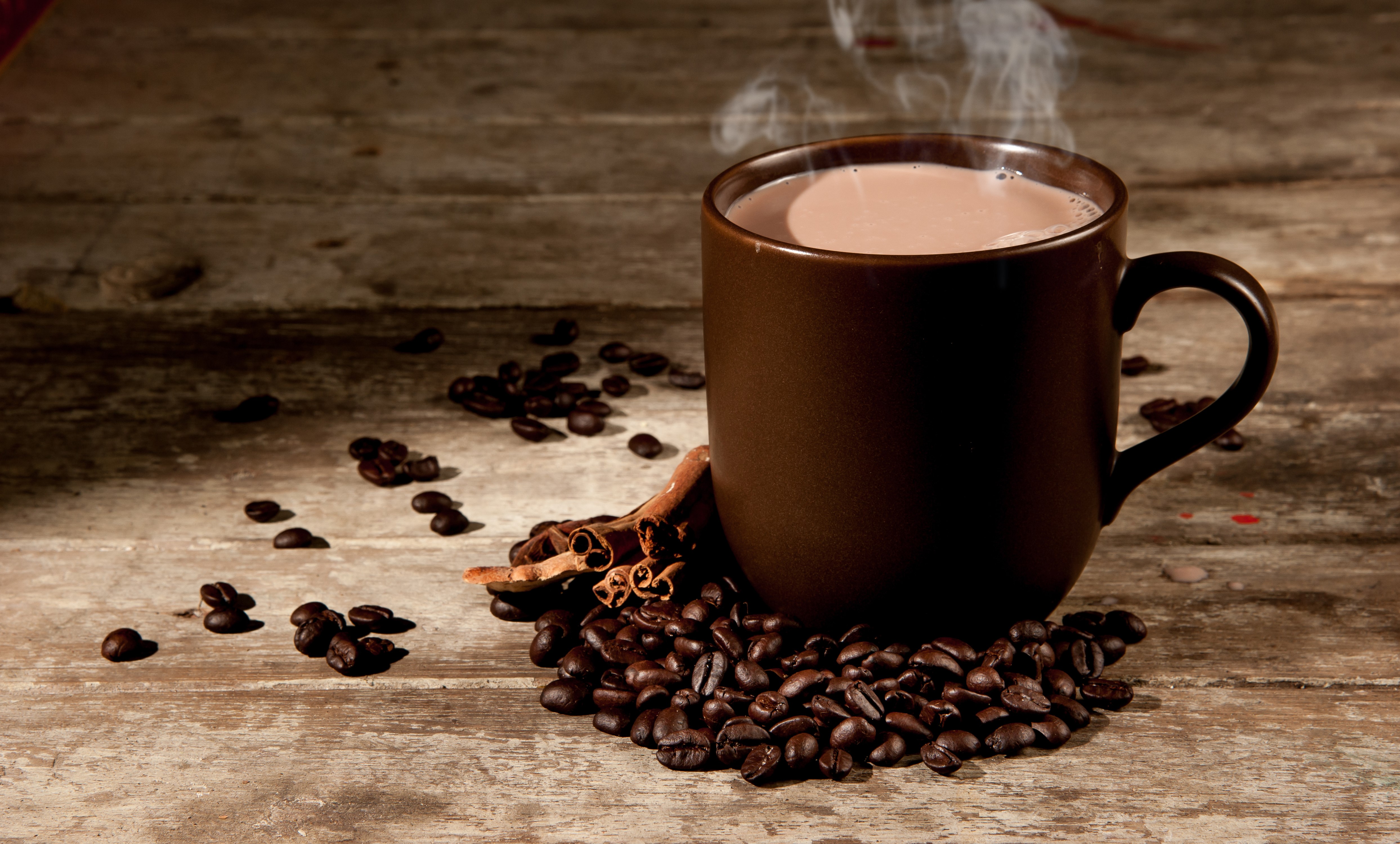 Coffee cup with beans and cinnamon on wood HD Wallpaper