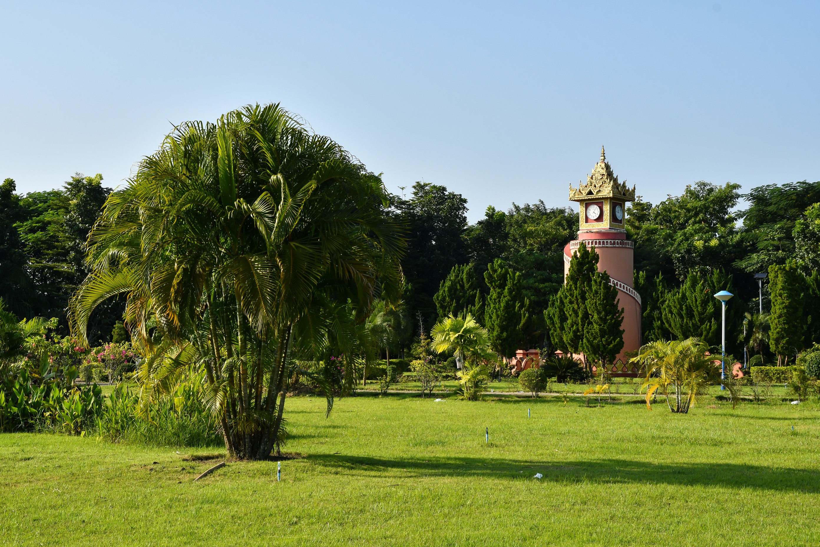 Clock tower in a park with palm trees in Naypyidaw, Myanmar HD Wallpaper