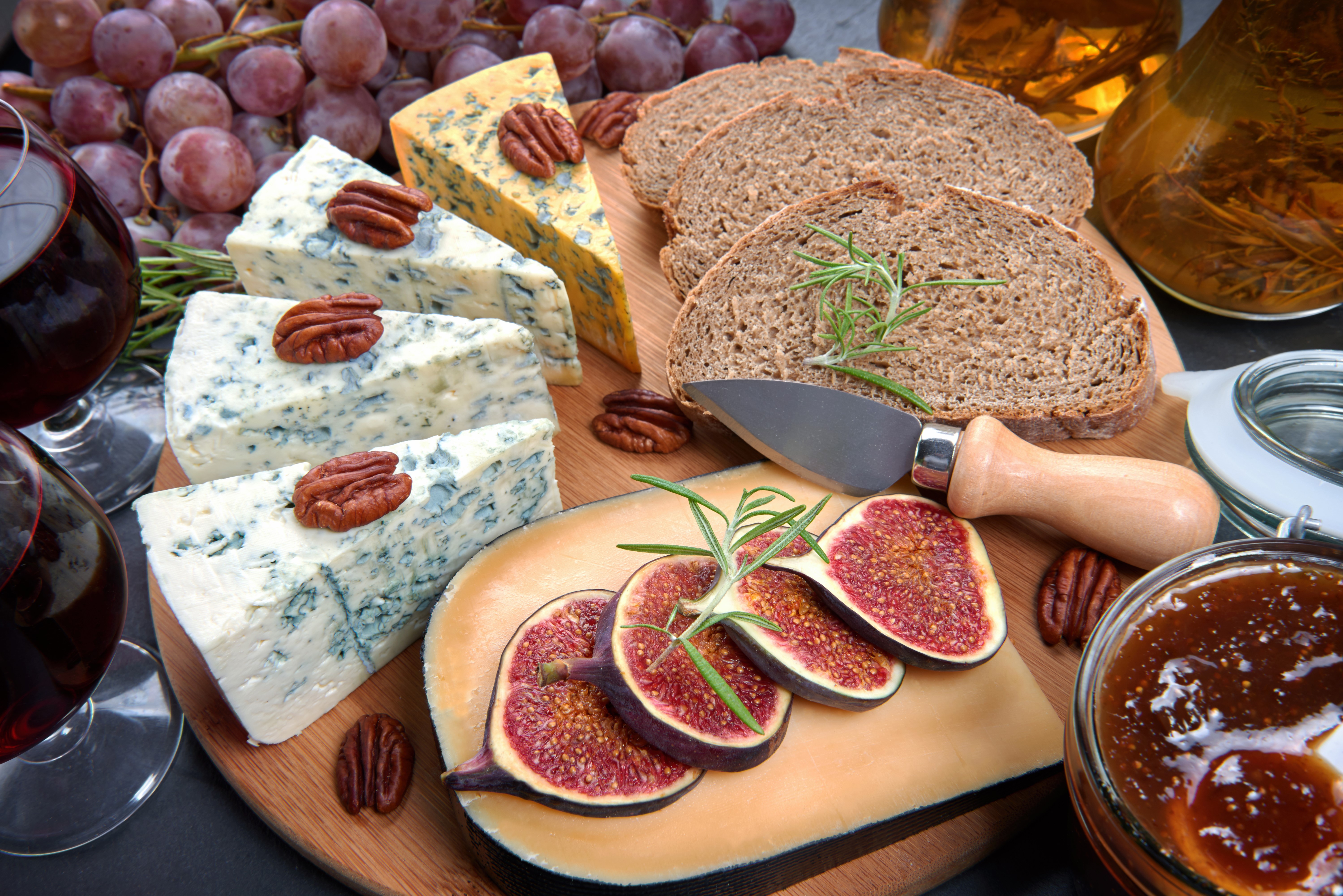 Cheese board with grapes, bread, figs, nuts, and wine HD Wallpaper