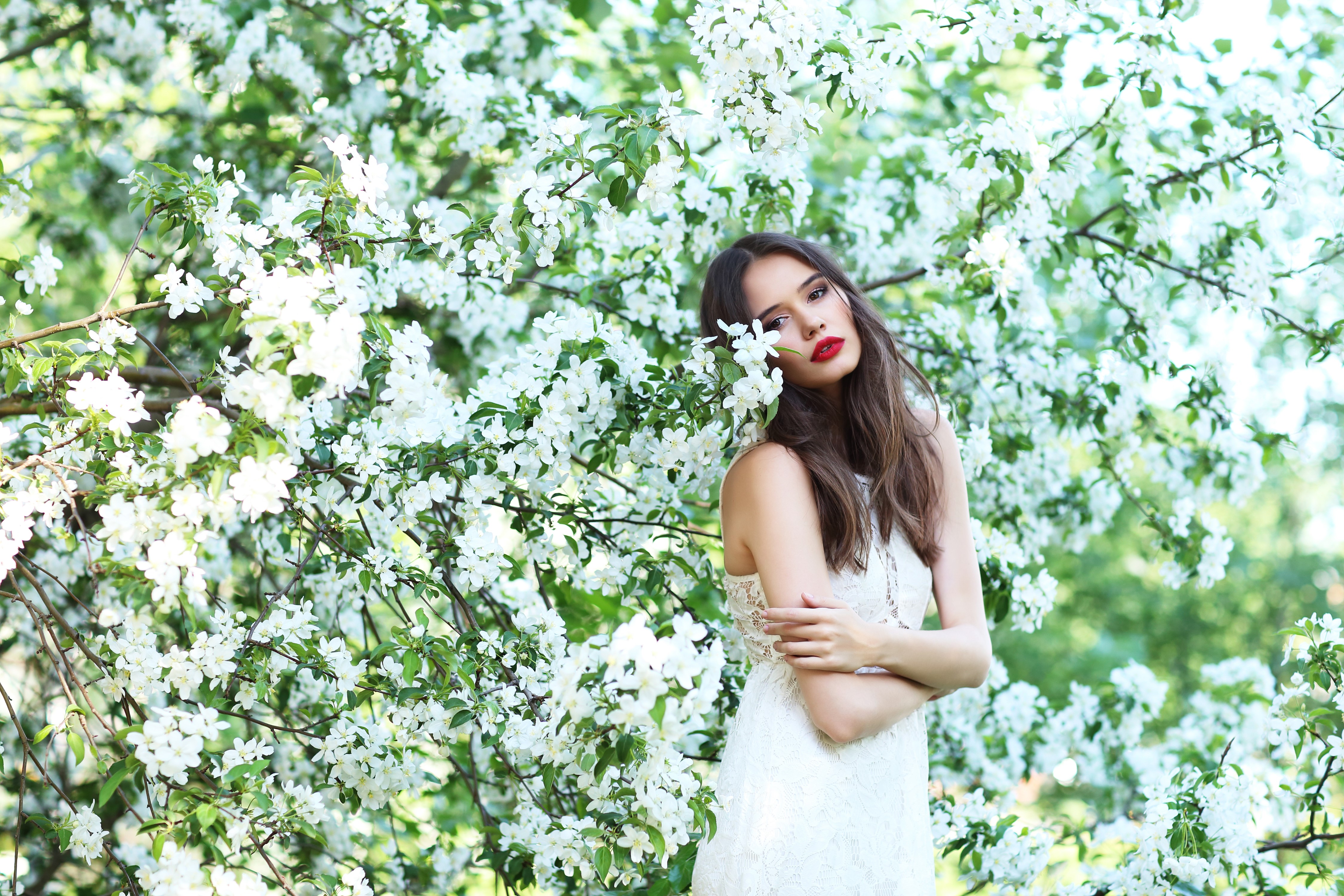 Woman in white dress among flowering trees HD Wallpaper