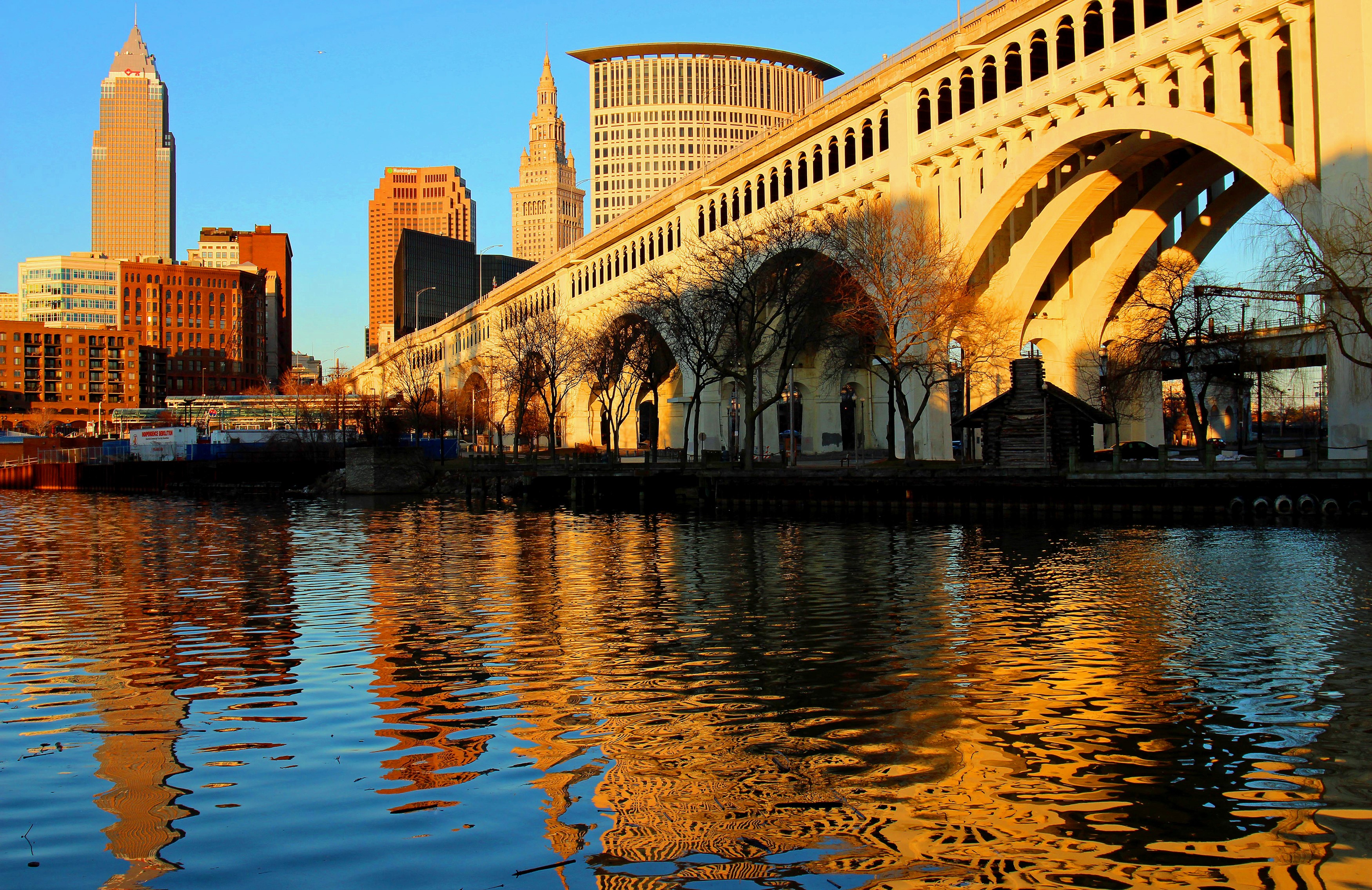 Cleveland skyline and bridge over river at sunset HD Wallpaper
