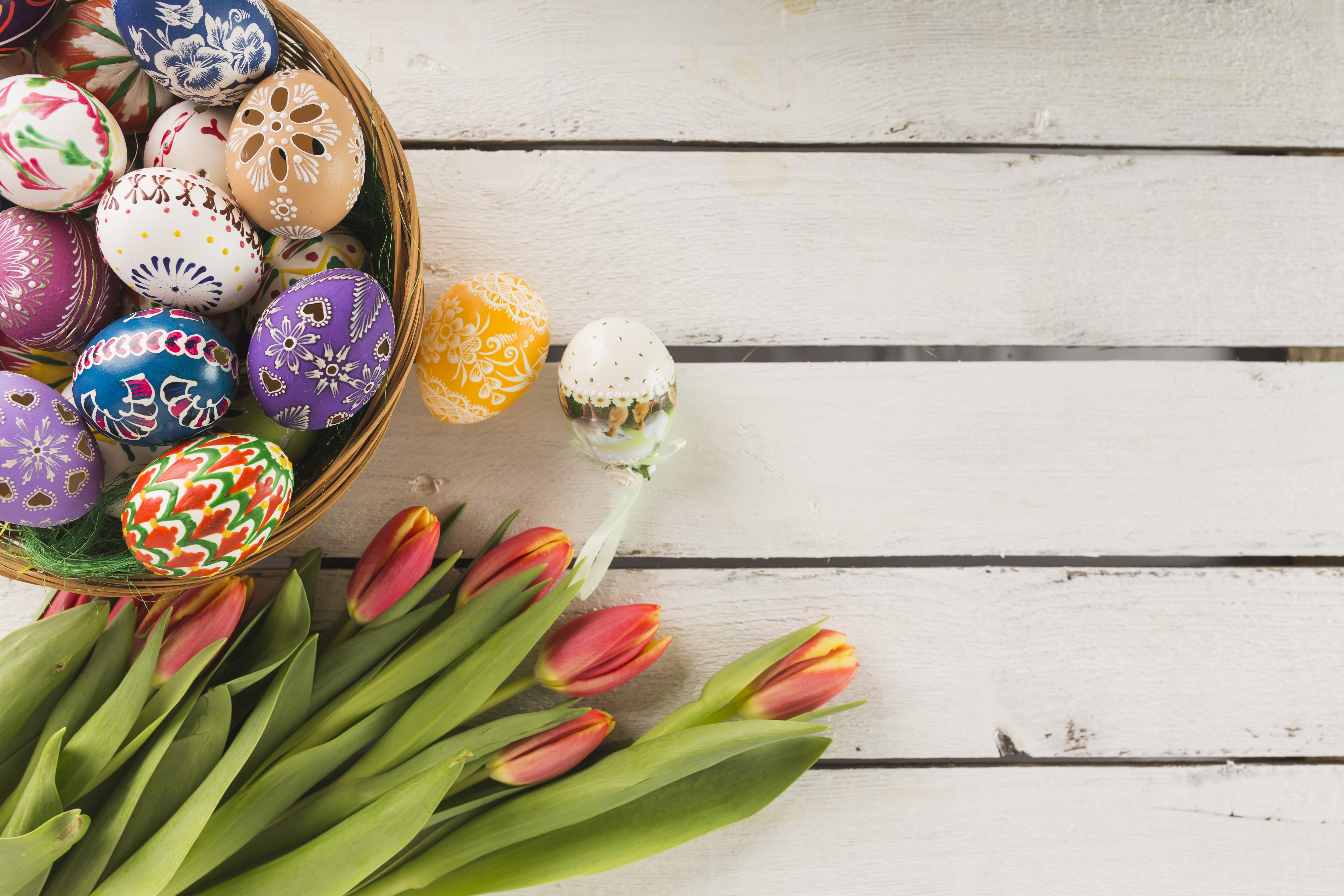 Easter Eggs in a Basket with Tulips on Wood Planks HD Wallpaper