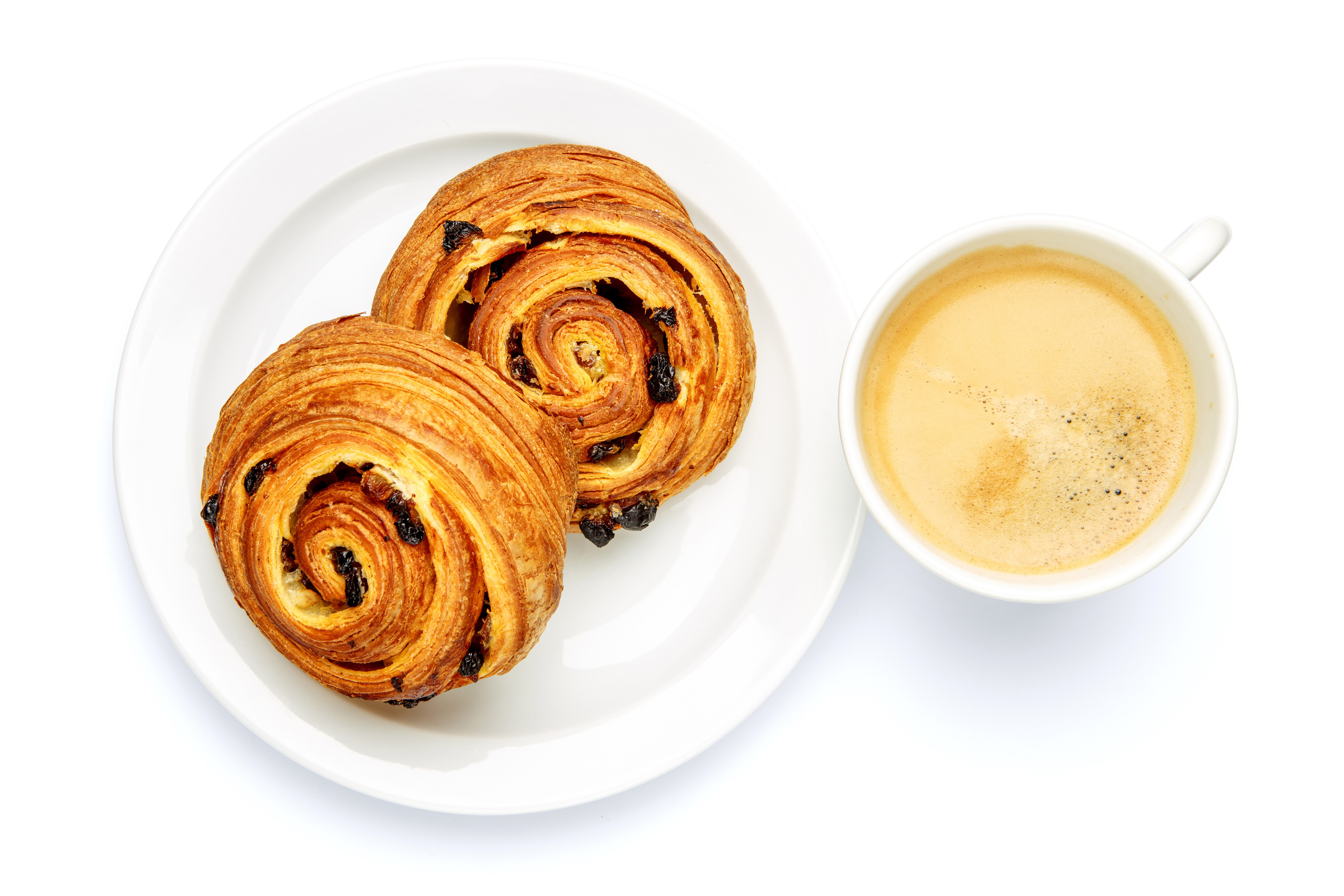 Two raisin buns on a plate with a cup of coffee HD Wallpaper