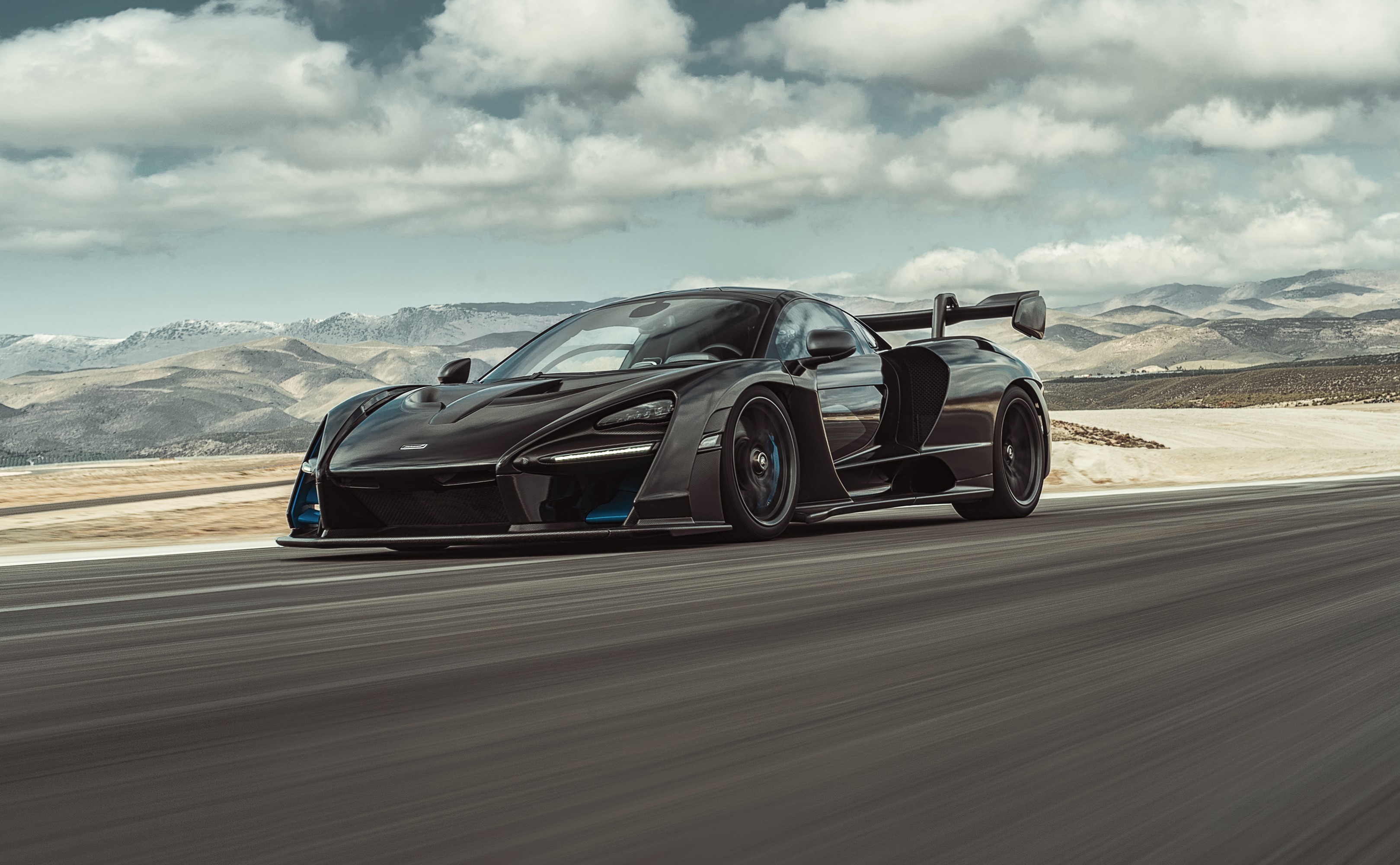 Black McLaren Senna driving on a road HD Wallpaper