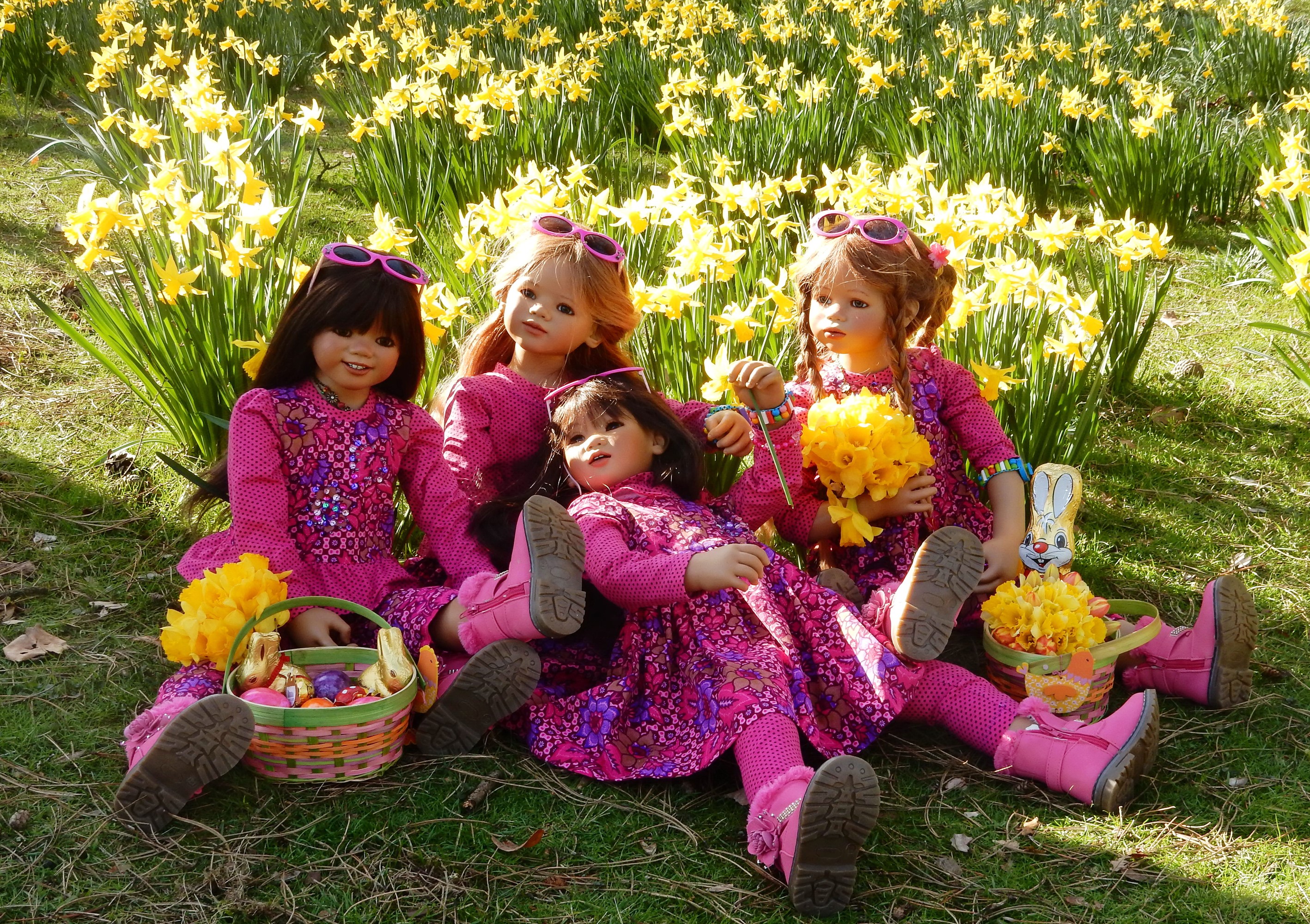 Dolls in pink dresses with Easter baskets in a field of daffodils HD Wallpaper
