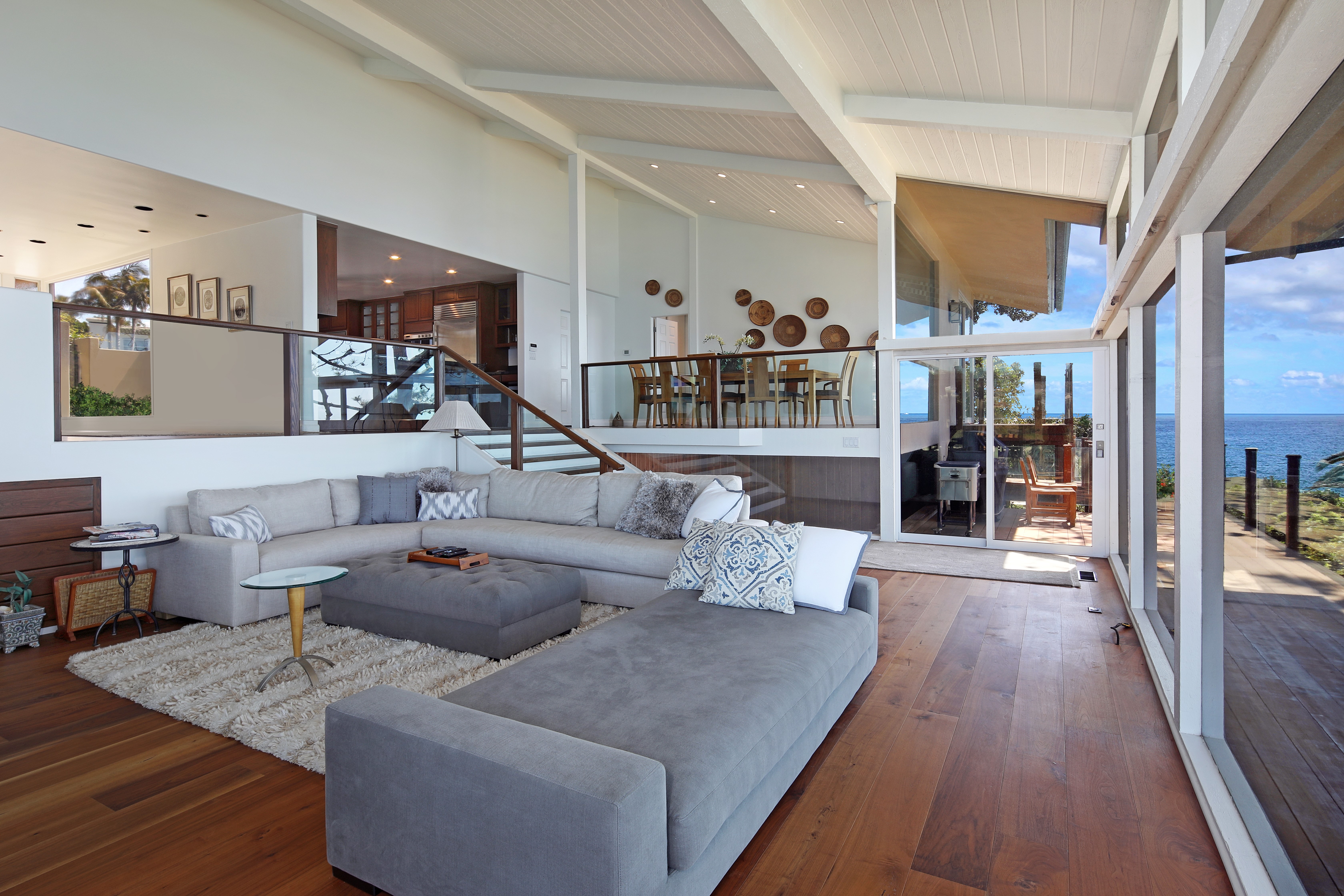 Living room with sectional sofa and ocean view HD Wallpaper