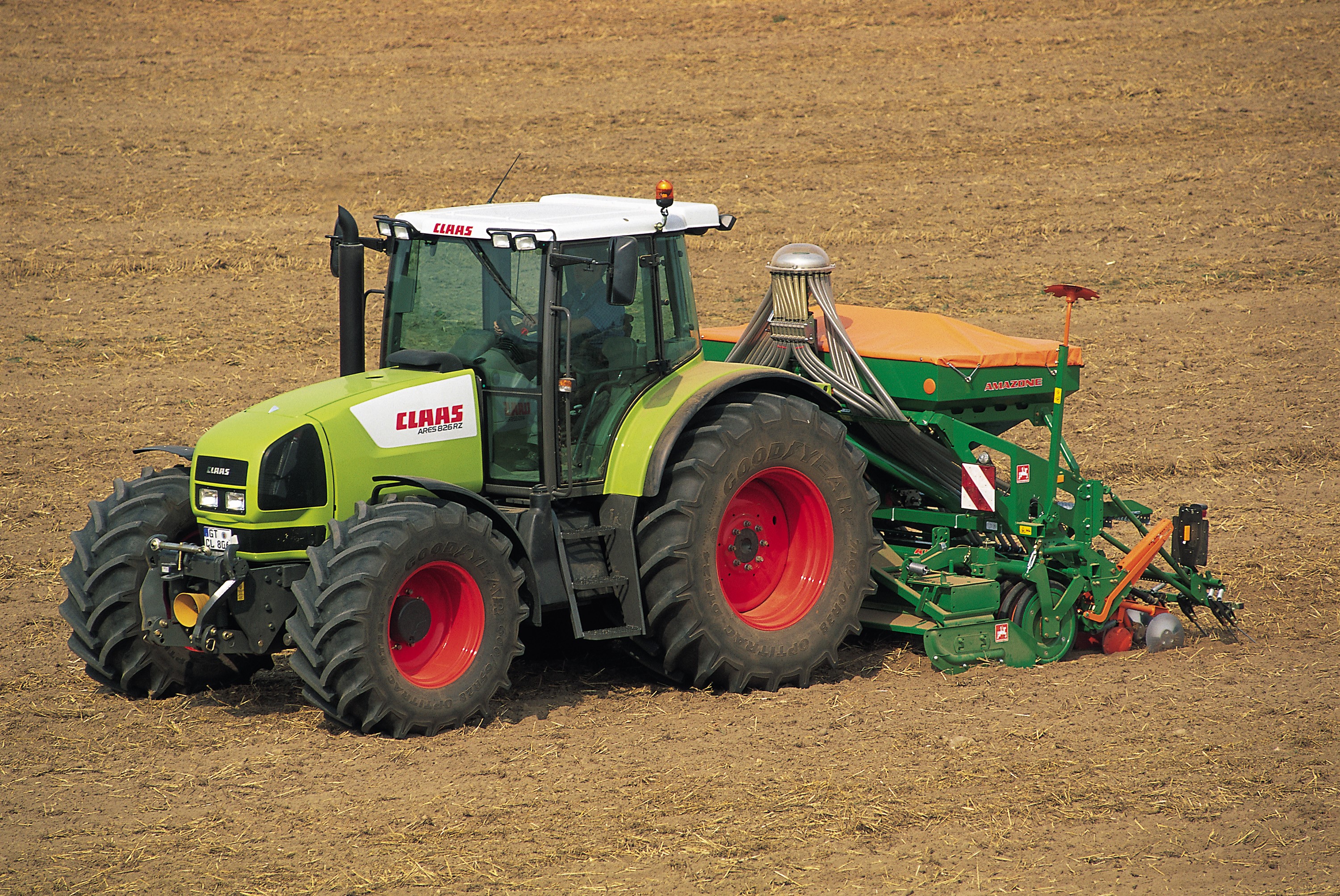 Claas Ares 826 RZ tractor with seeder in a field HD Wallpaper