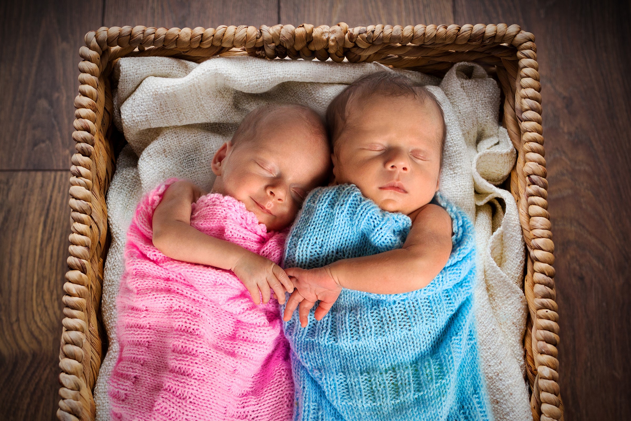 Two Newborn Twins Sleeping in a Basket HD Wallpaper