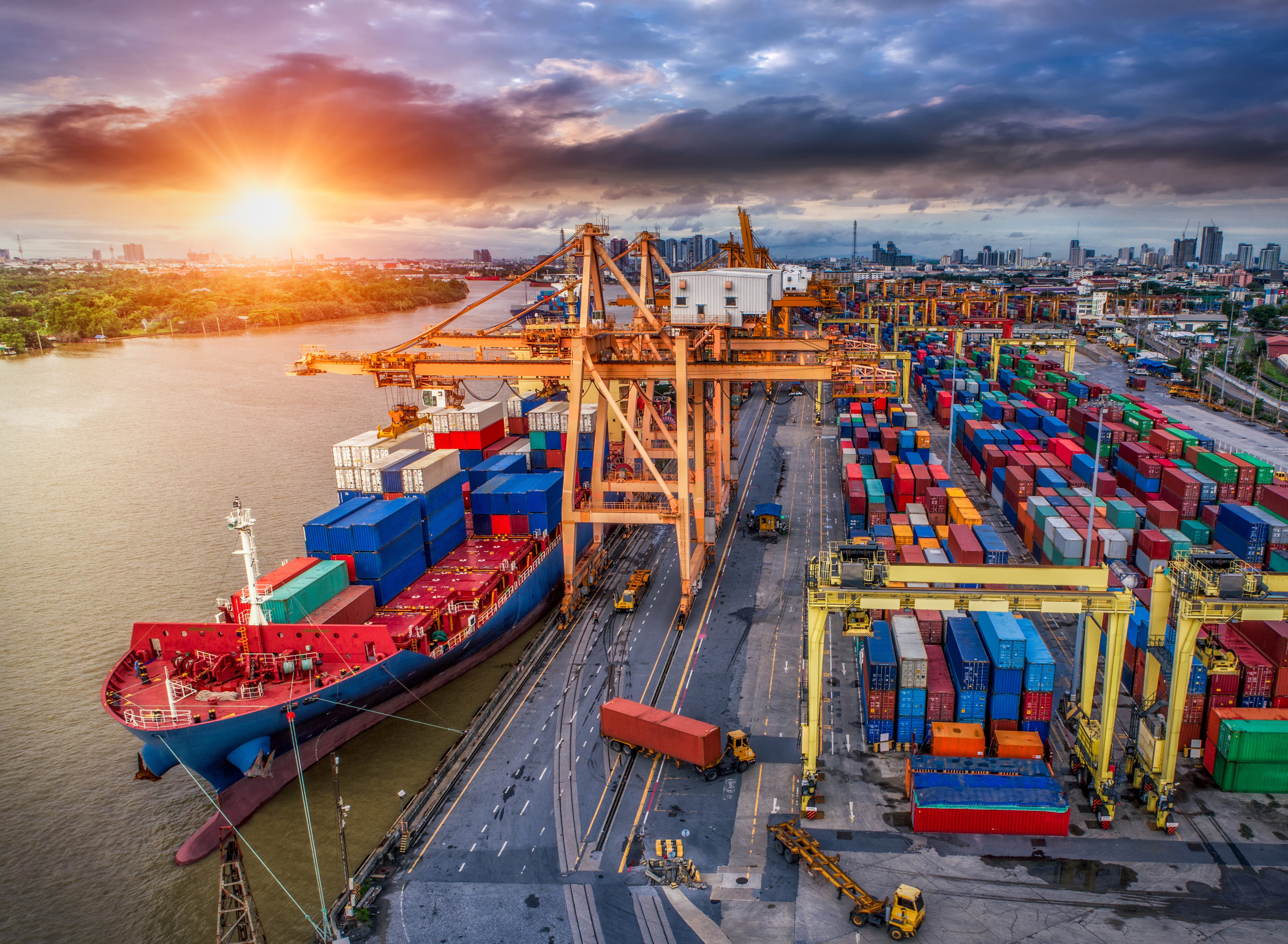 Container ship at a busy port during sunset HD Wallpaper