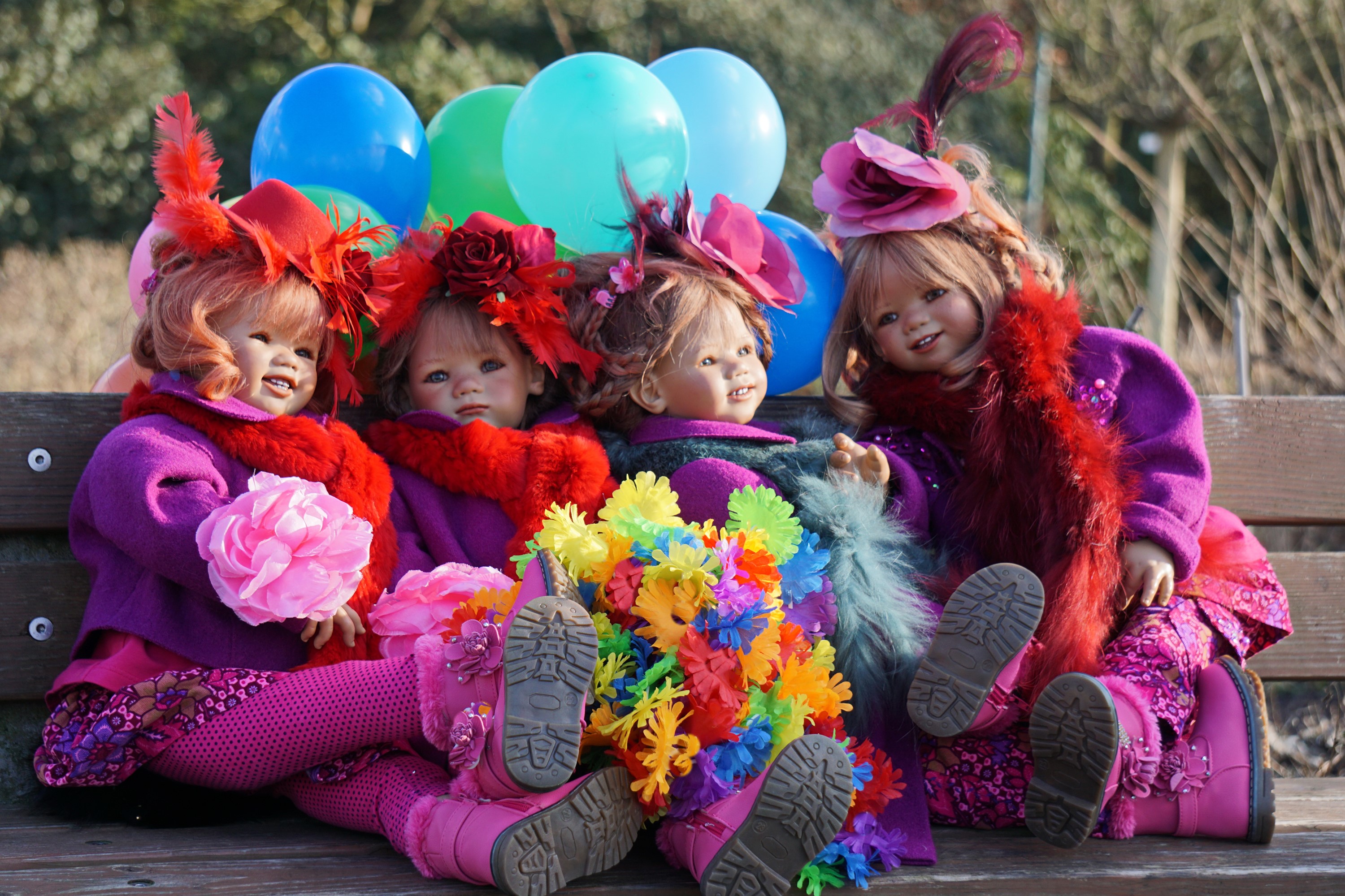 Four dolls with balloons and flowers in a park HD Wallpaper