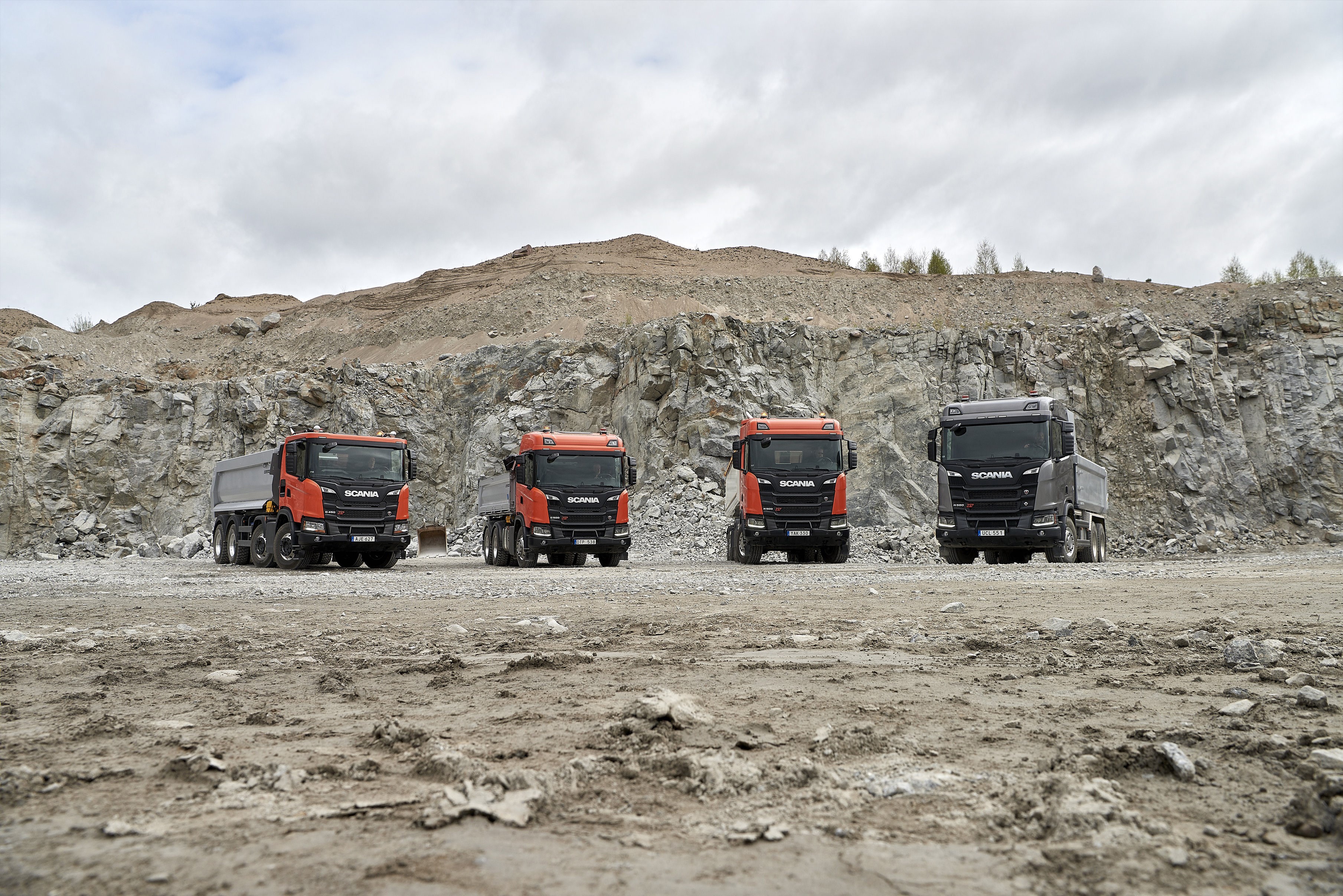 Four Scania trucks in a quarry HD Wallpaper