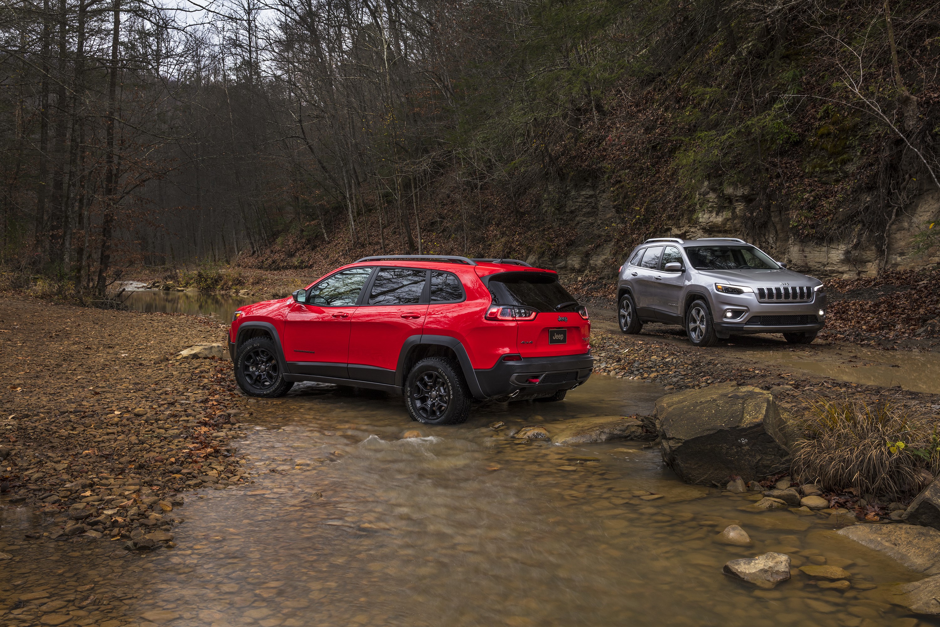 Two Jeep Cherokees driving through a stream HD Wallpaper