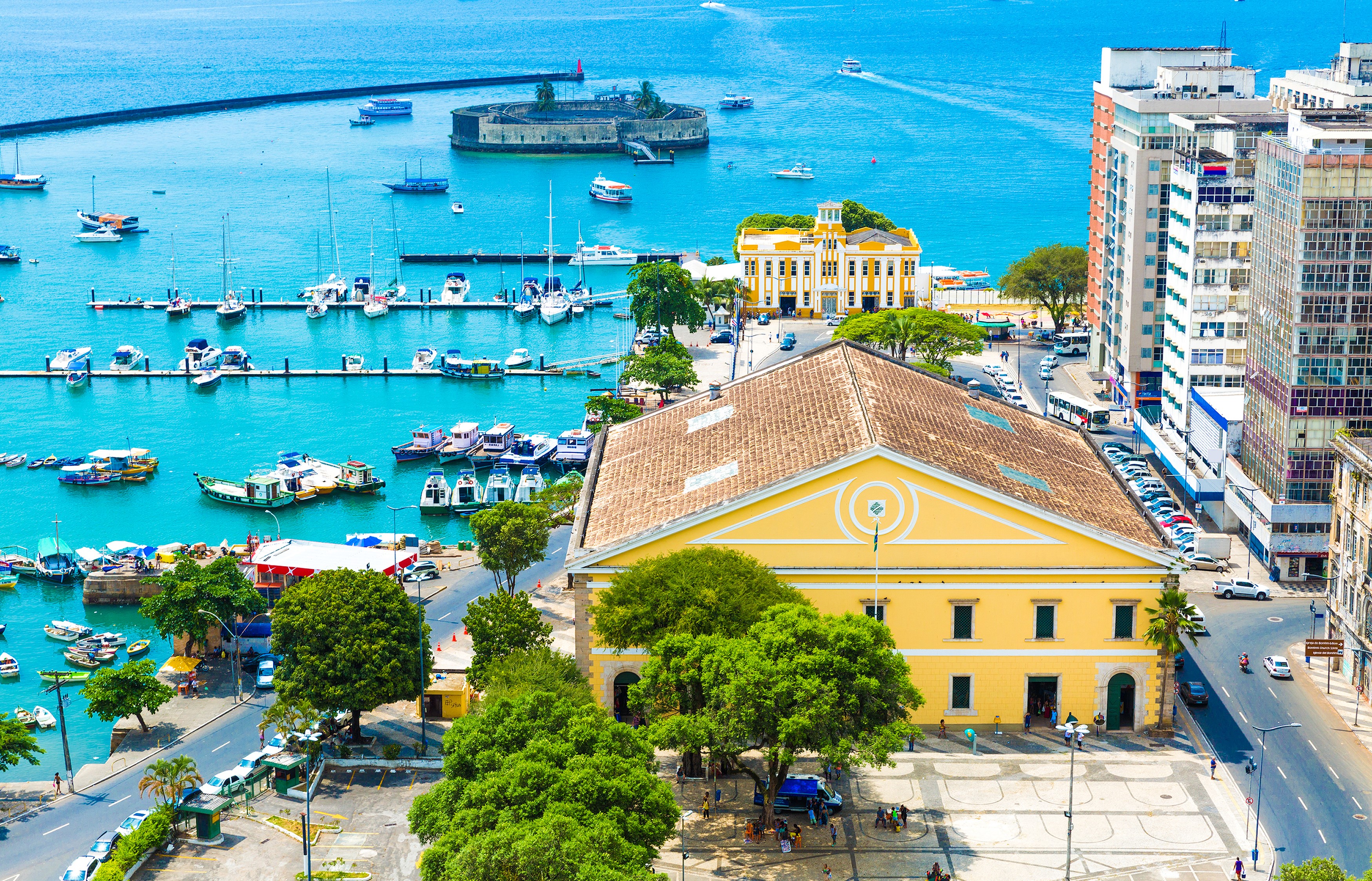 Coastal city with marina and historic buildings HD Wallpaper