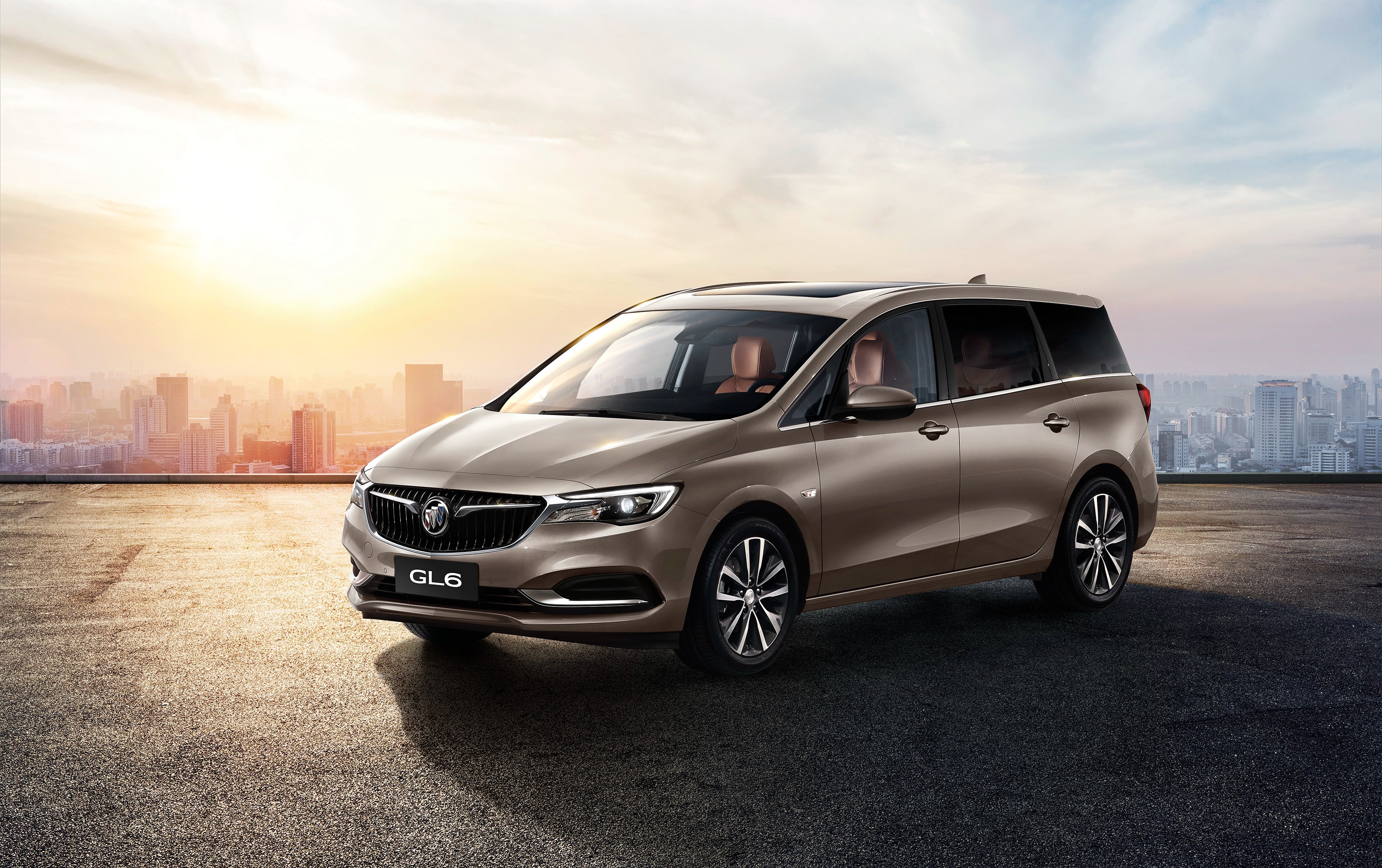 Buick GL6 MPV on rooftop with city skyline HD Wallpaper
