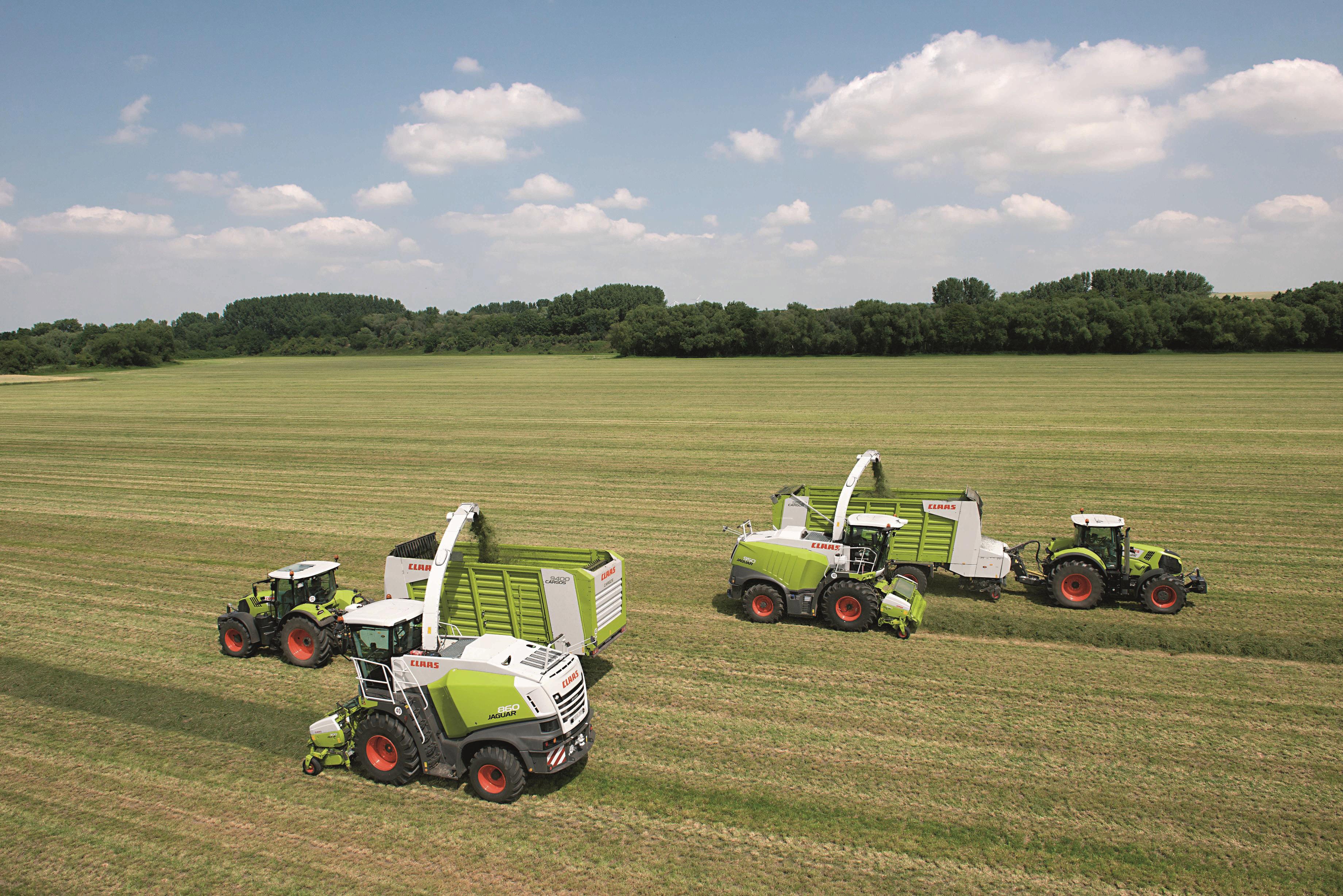 Claas agricultural machinery harvesting a field HD Wallpaper