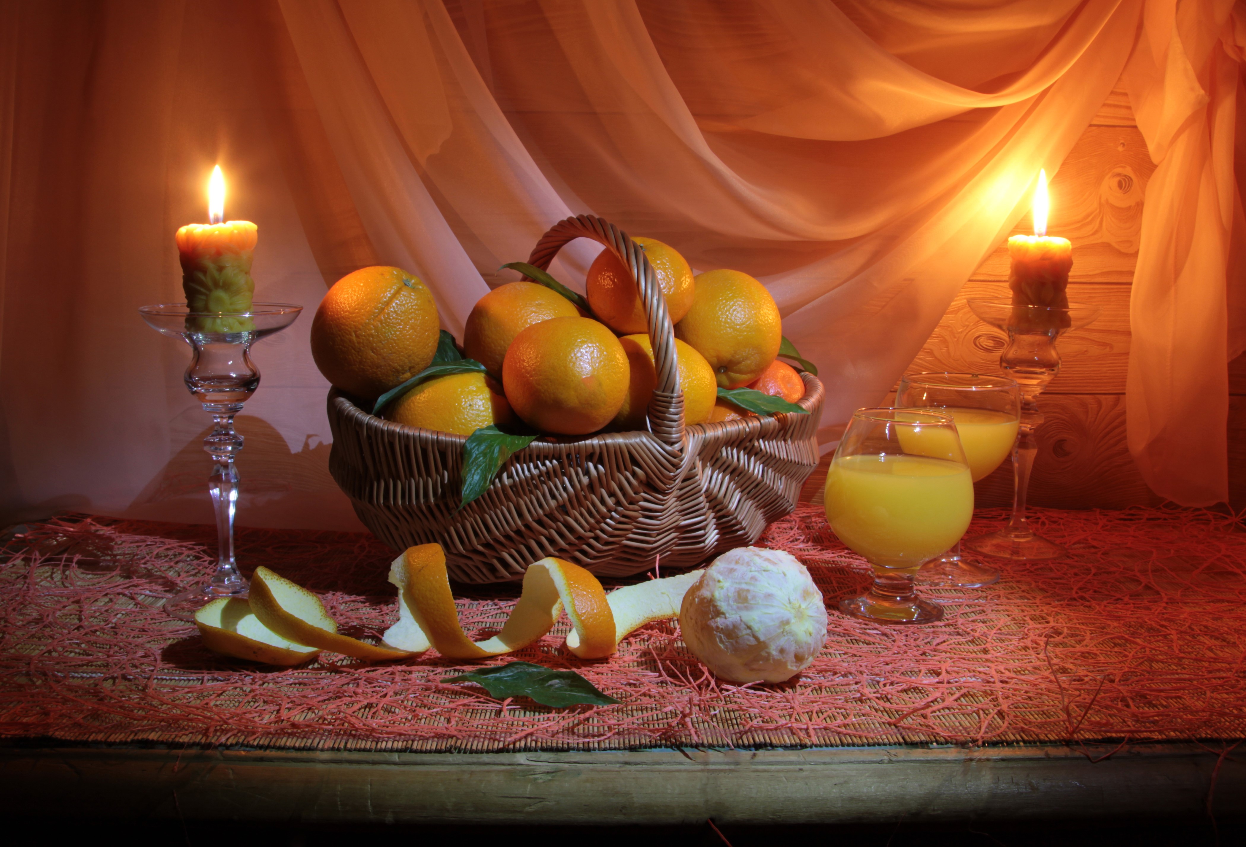 Oranges in a basket with candles and juice HD Wallpaper