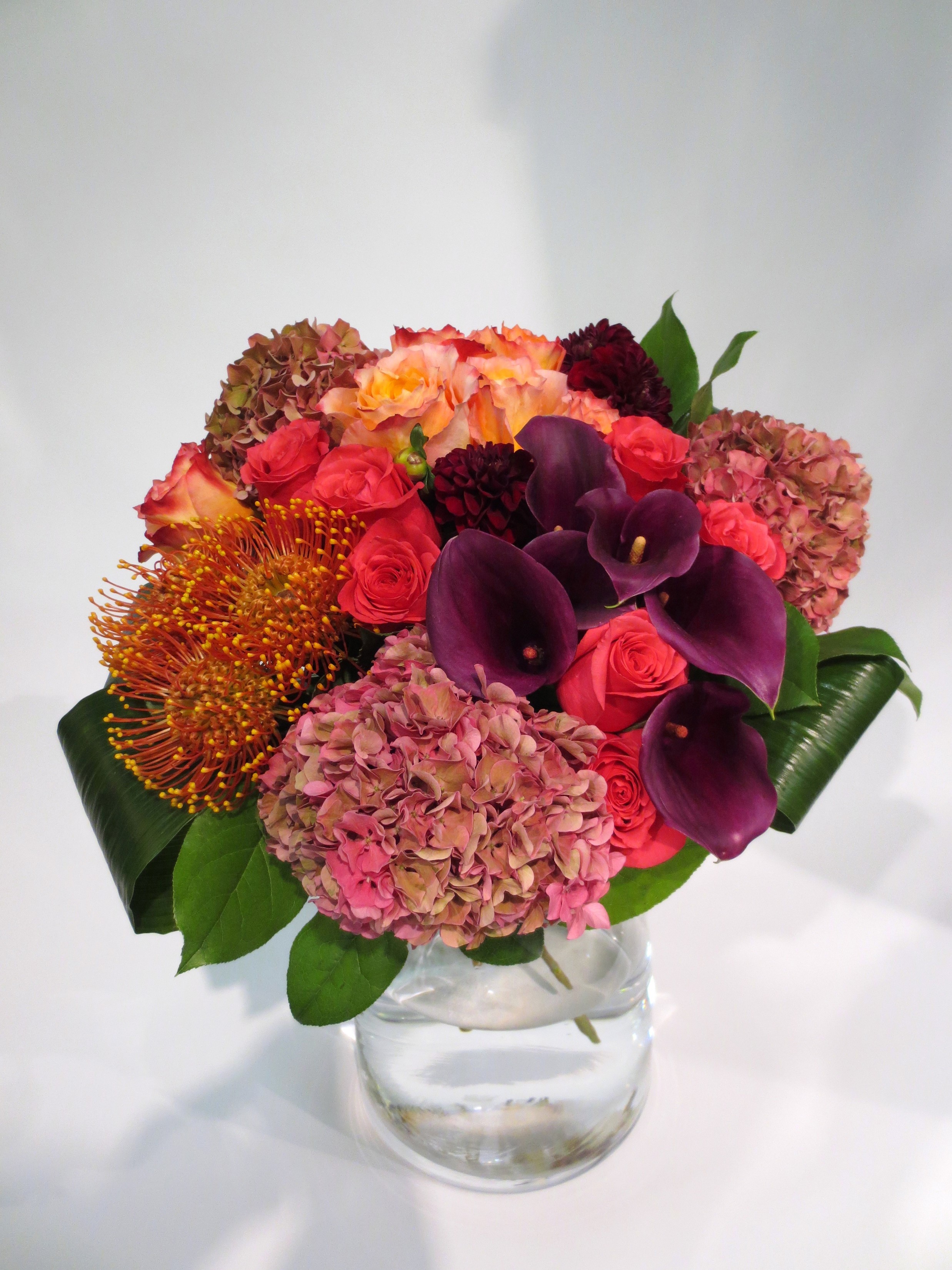 Floral arrangement with roses, calla lilies, and hydrangeas in a vase HD Phone Wallpaper