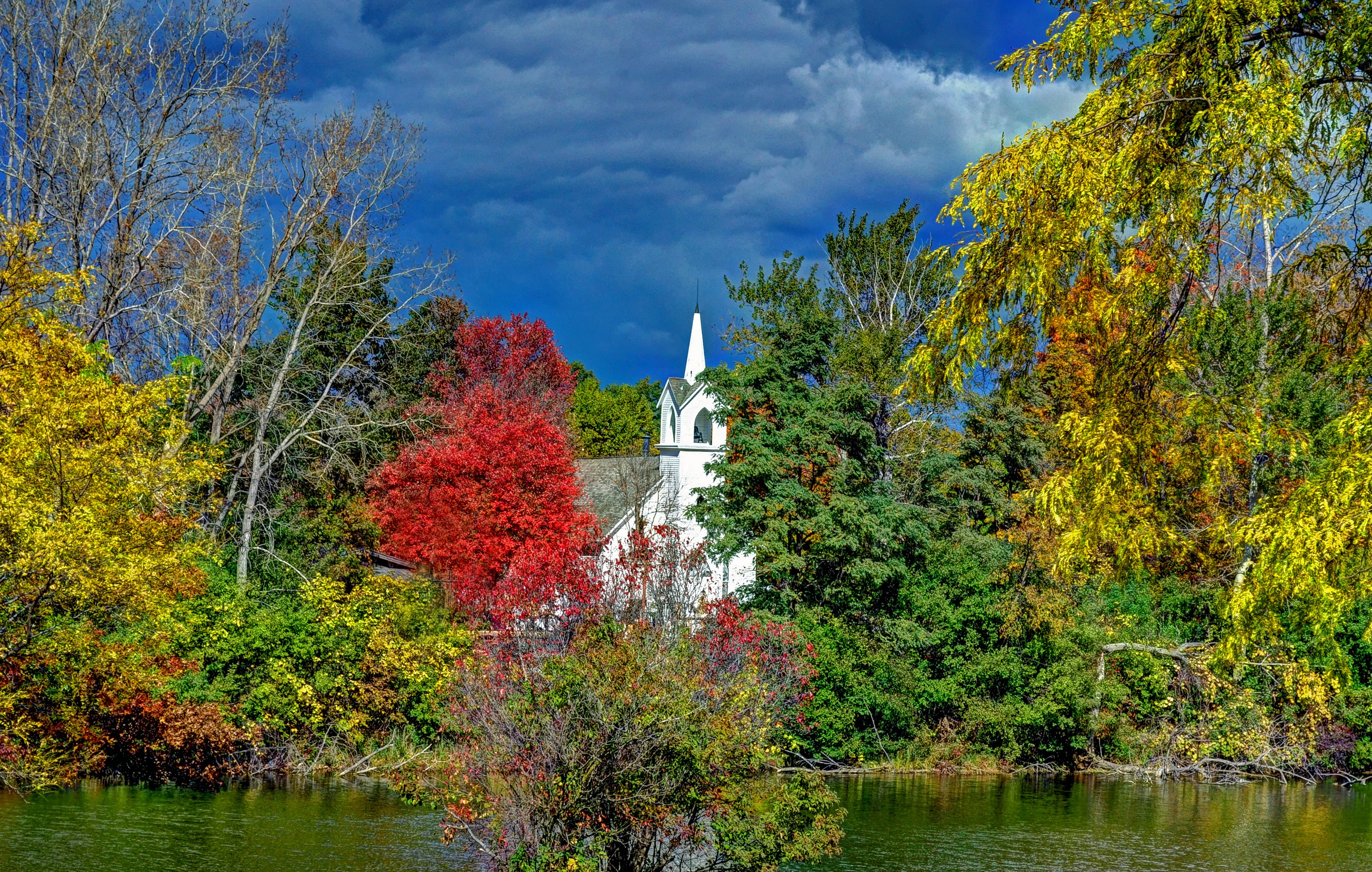 White church surrounded by autumn trees and a lake HD Wallpaper