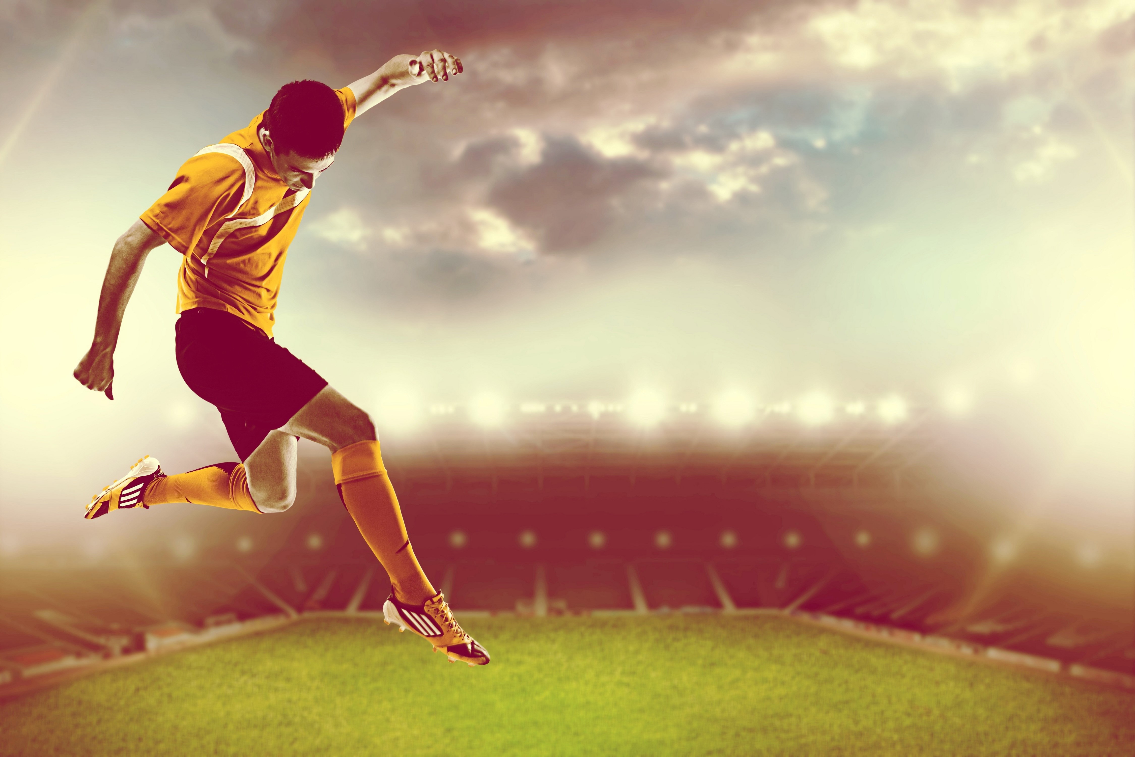 Man in uniform jumping in stadium HD Wallpaper