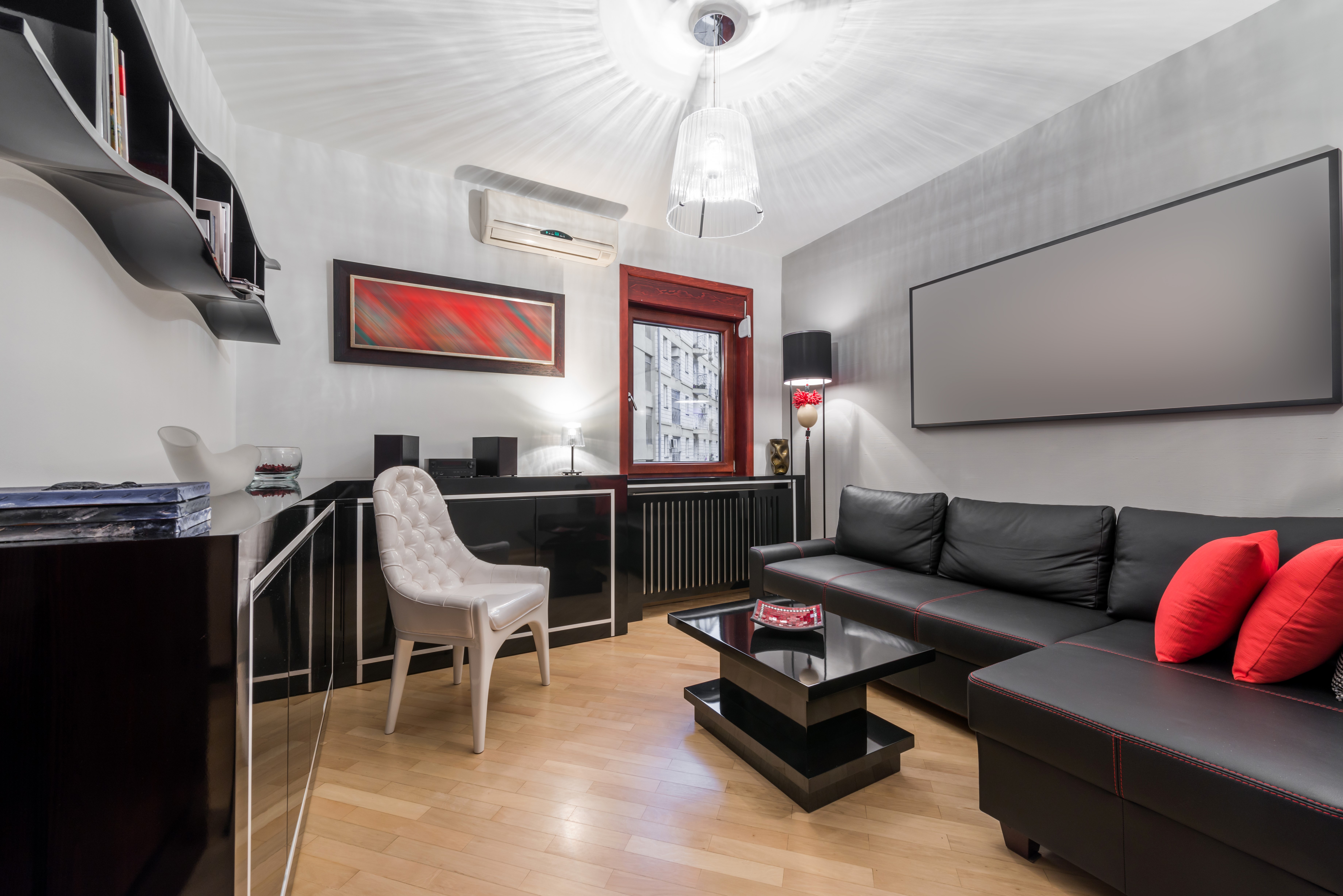 Modern Living Room with Black Sofa and White Chair HD Wallpaper
