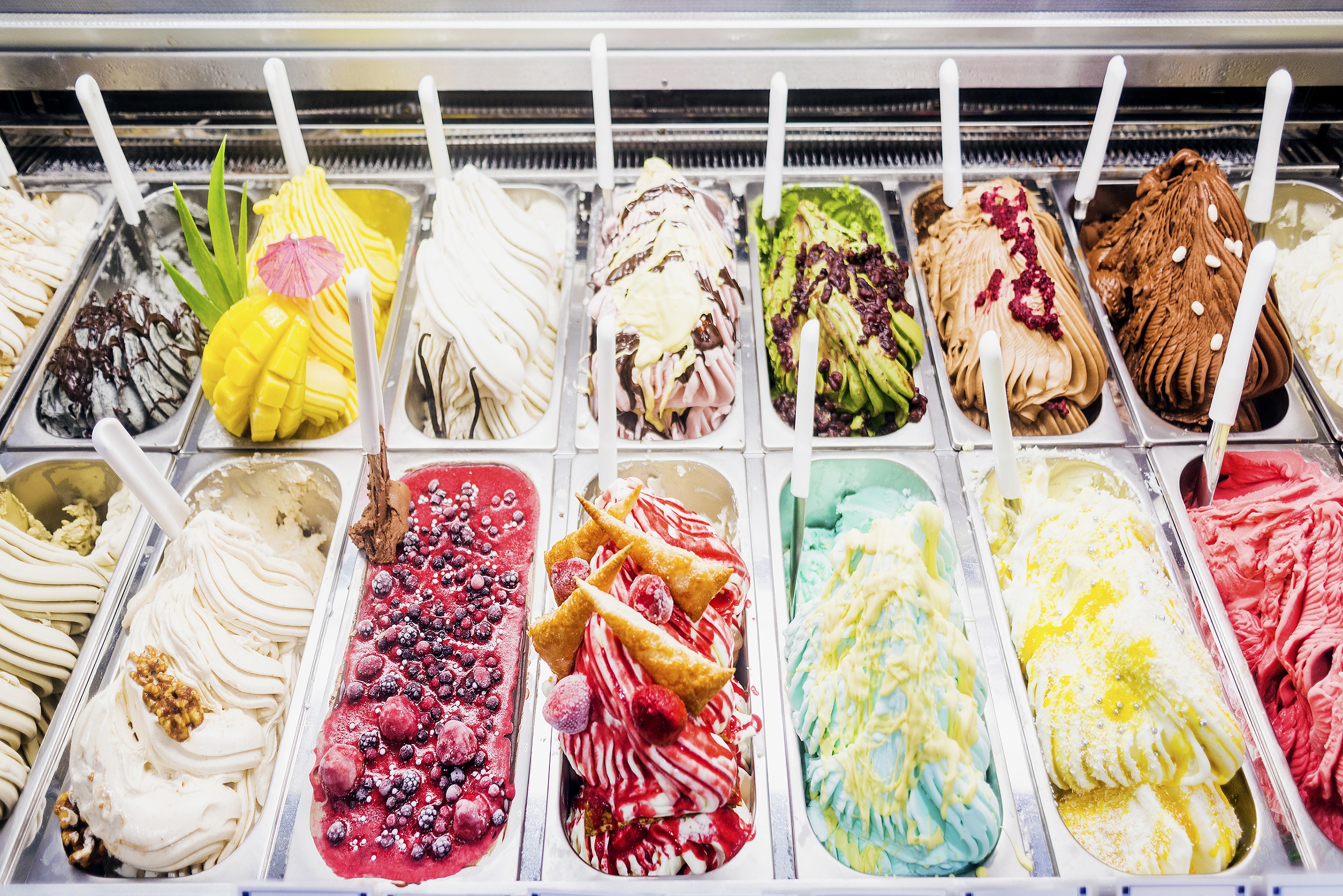 Assortment of colorful gelato flavors in a display case HD Wallpaper