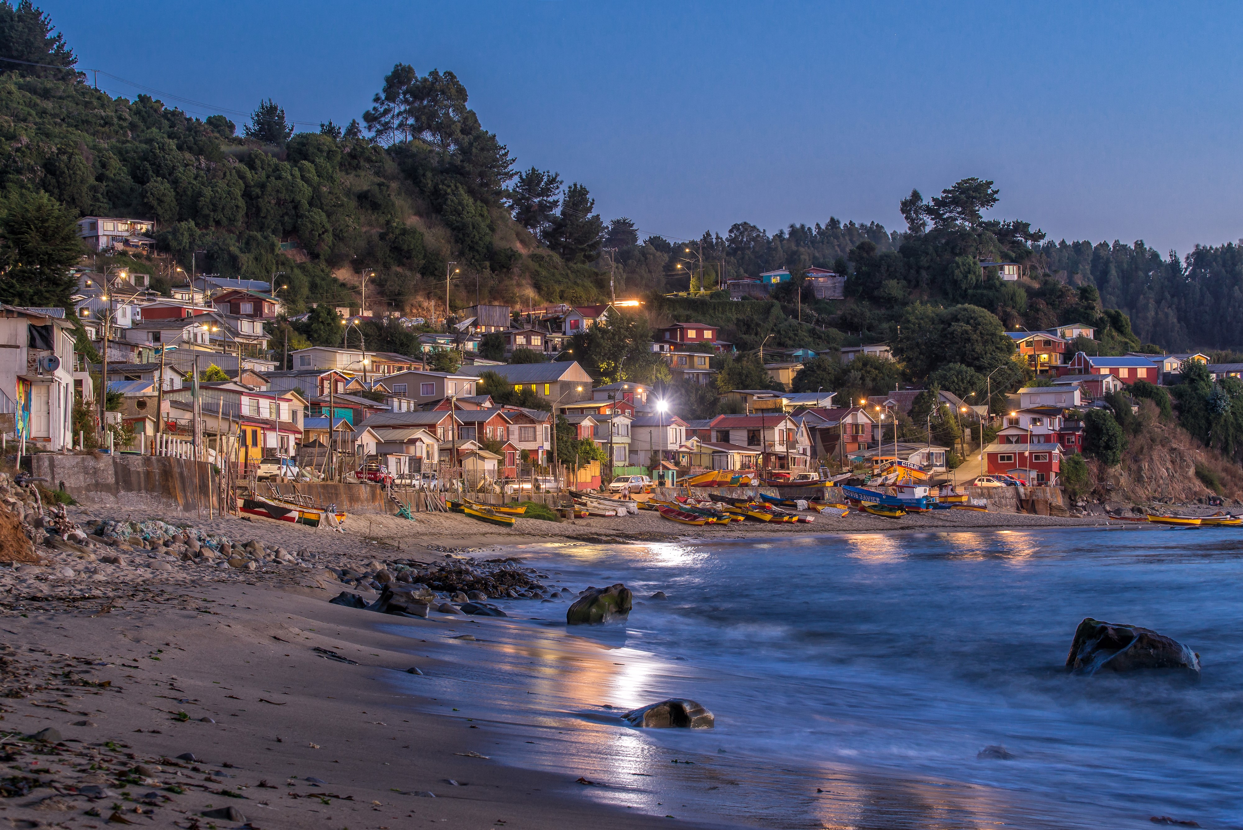 Evening view of Tome, Chile coast with houses and boats HD Wallpaper