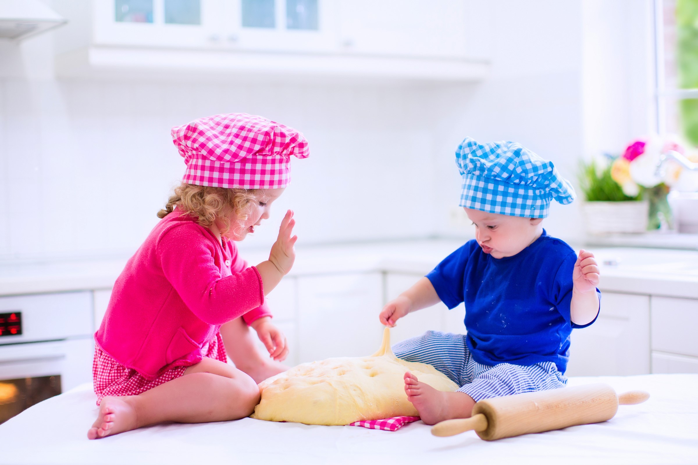 Two children in chef hats playing with dough HD Wallpaper