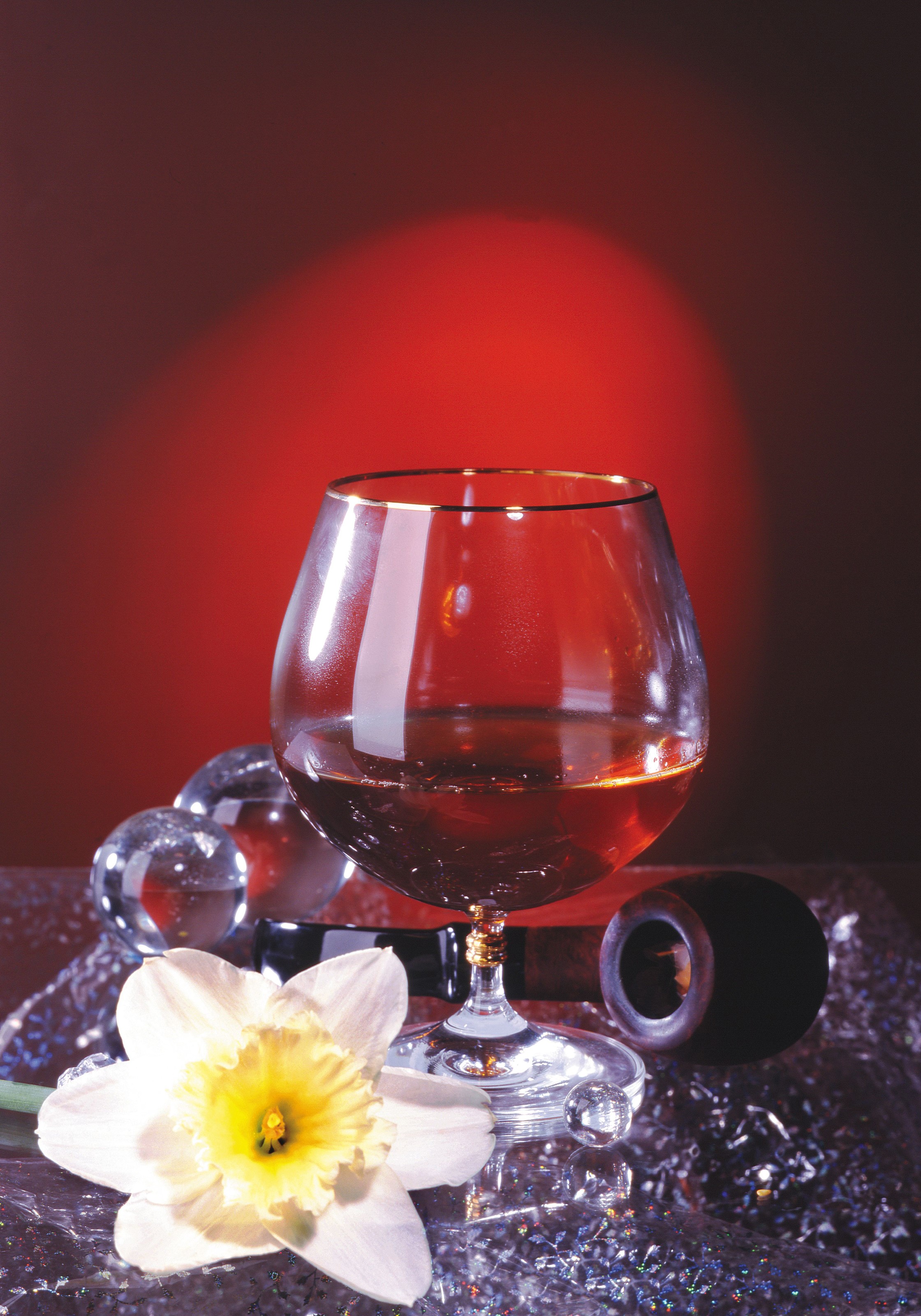 Brandy glass with daffodil and glass spheres HD Phone Wallpaper