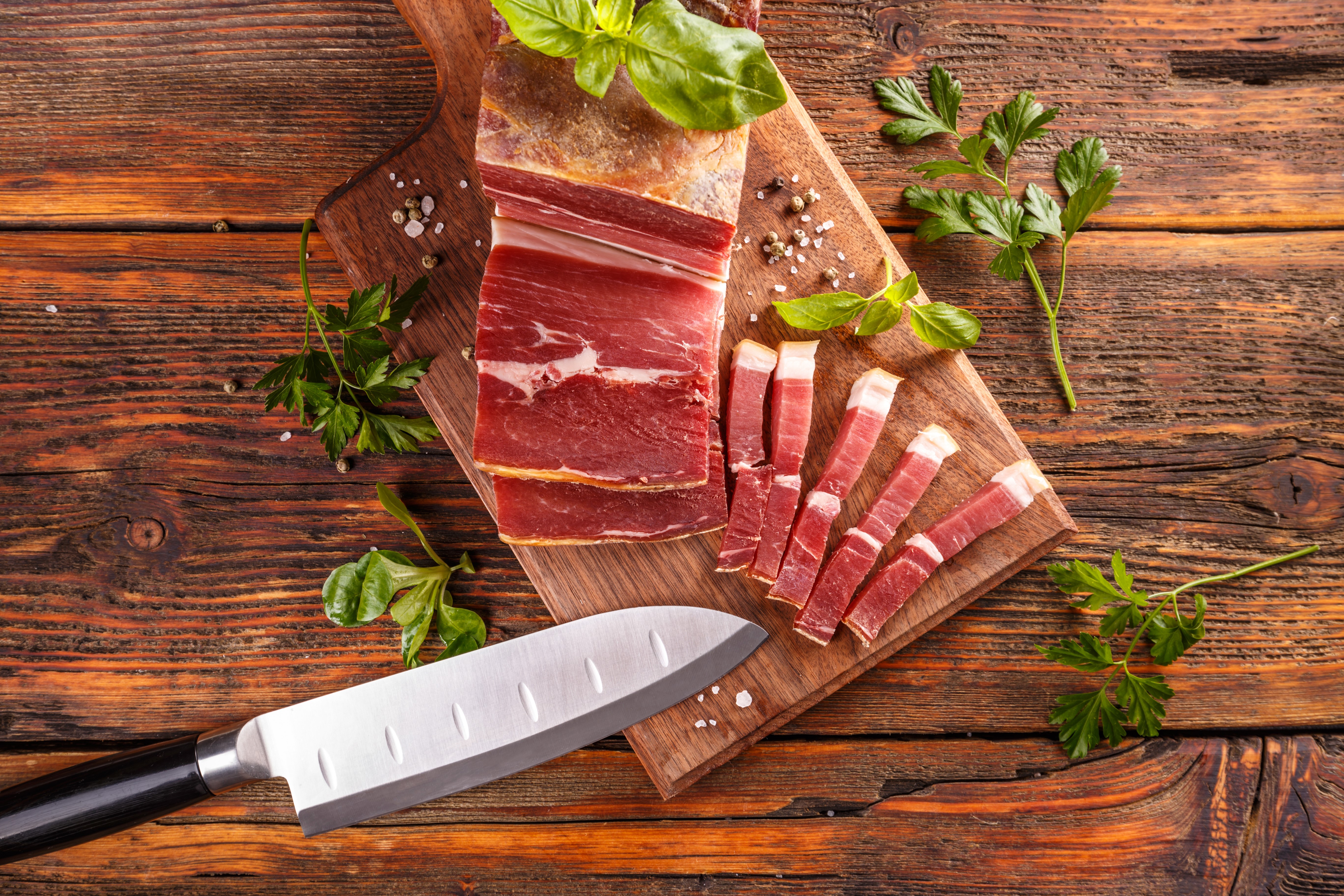 Ham on a cutting board with a knife HD Wallpaper