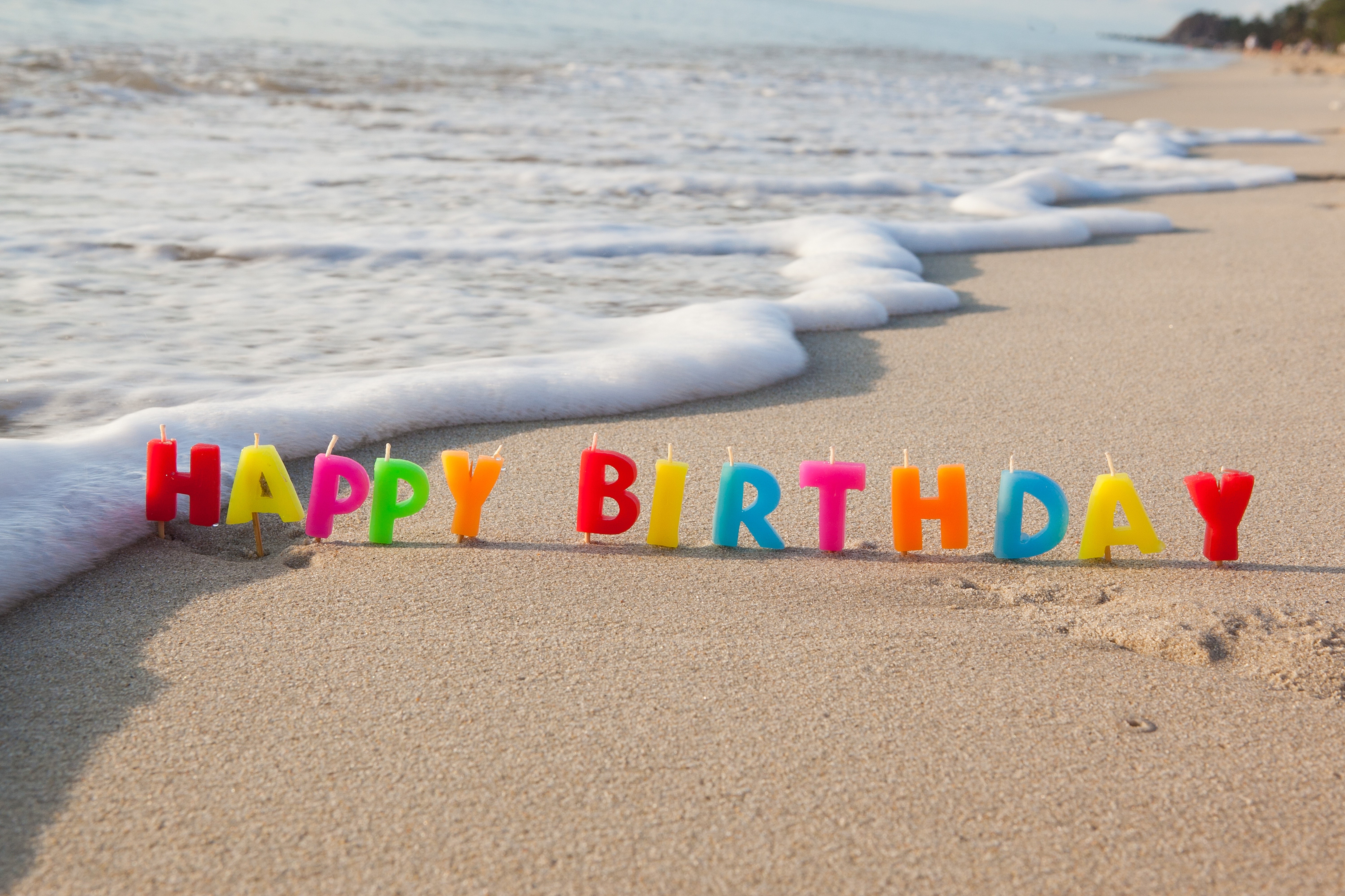 Happy Birthday candles on a beach with waves HD Wallpaper