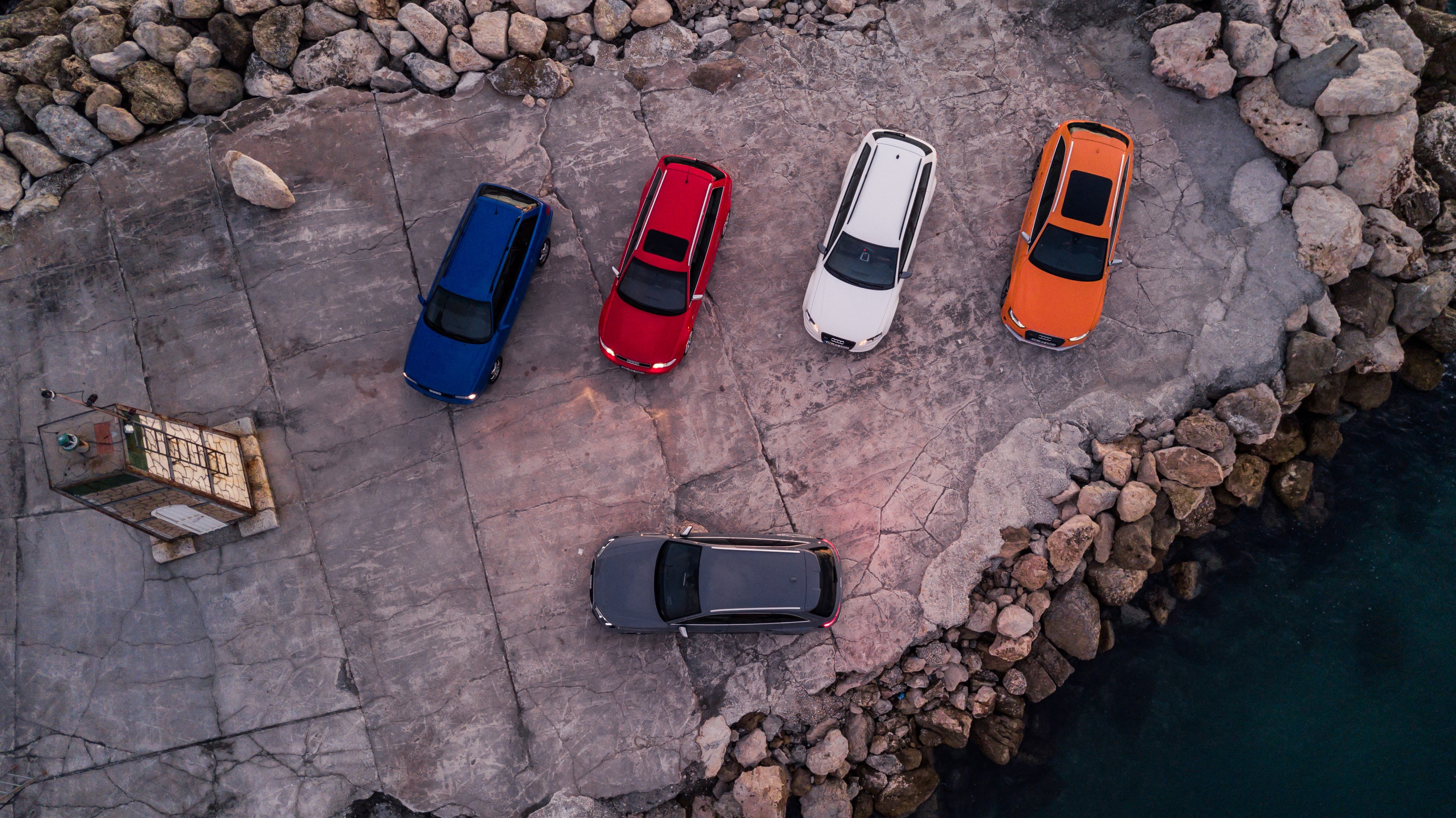 Audi RS2 and RS4 Avant cars parked on a rocky shore HD Wallpaper