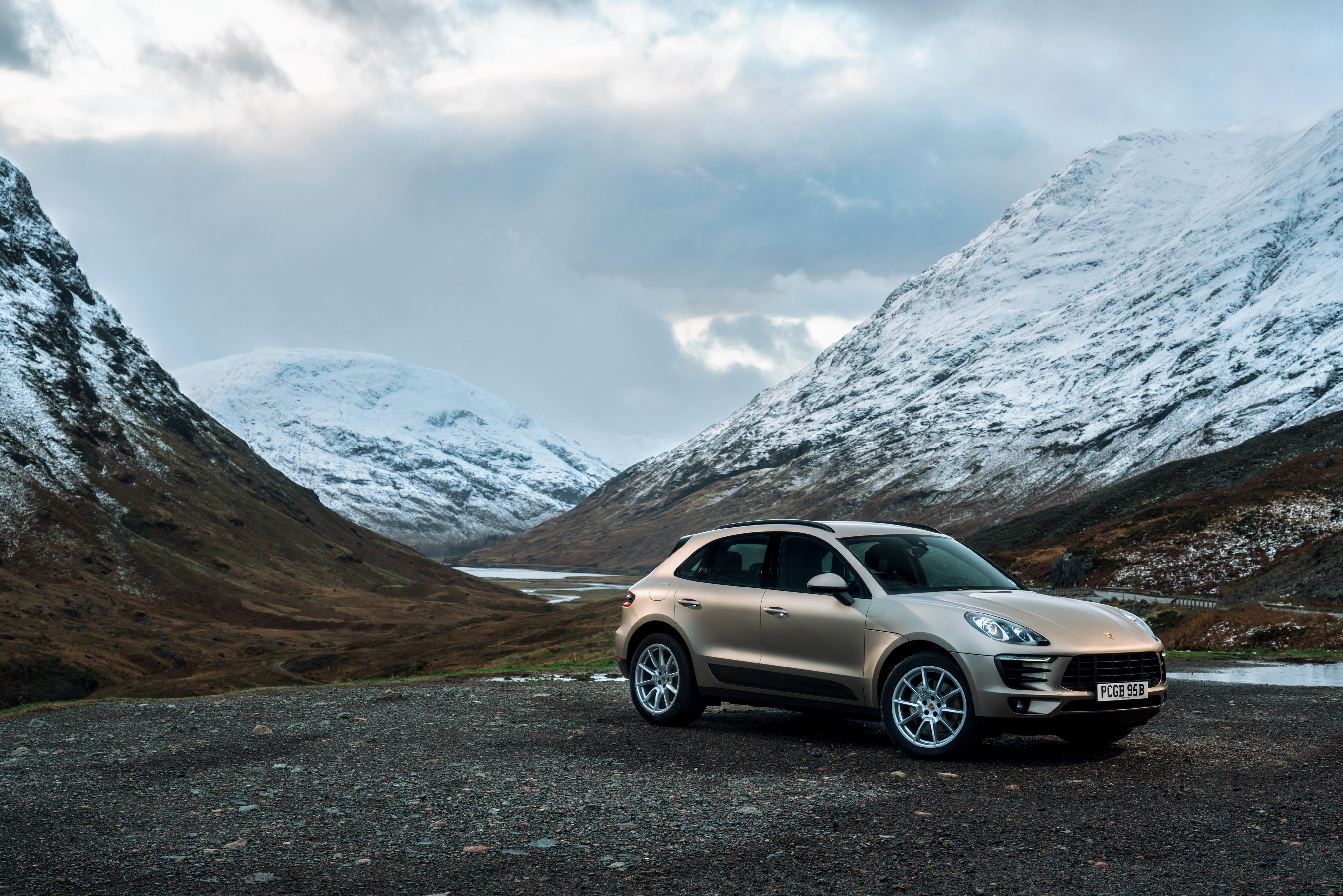 Porsche Macan S in a snowy mountain valley HD Wallpaper