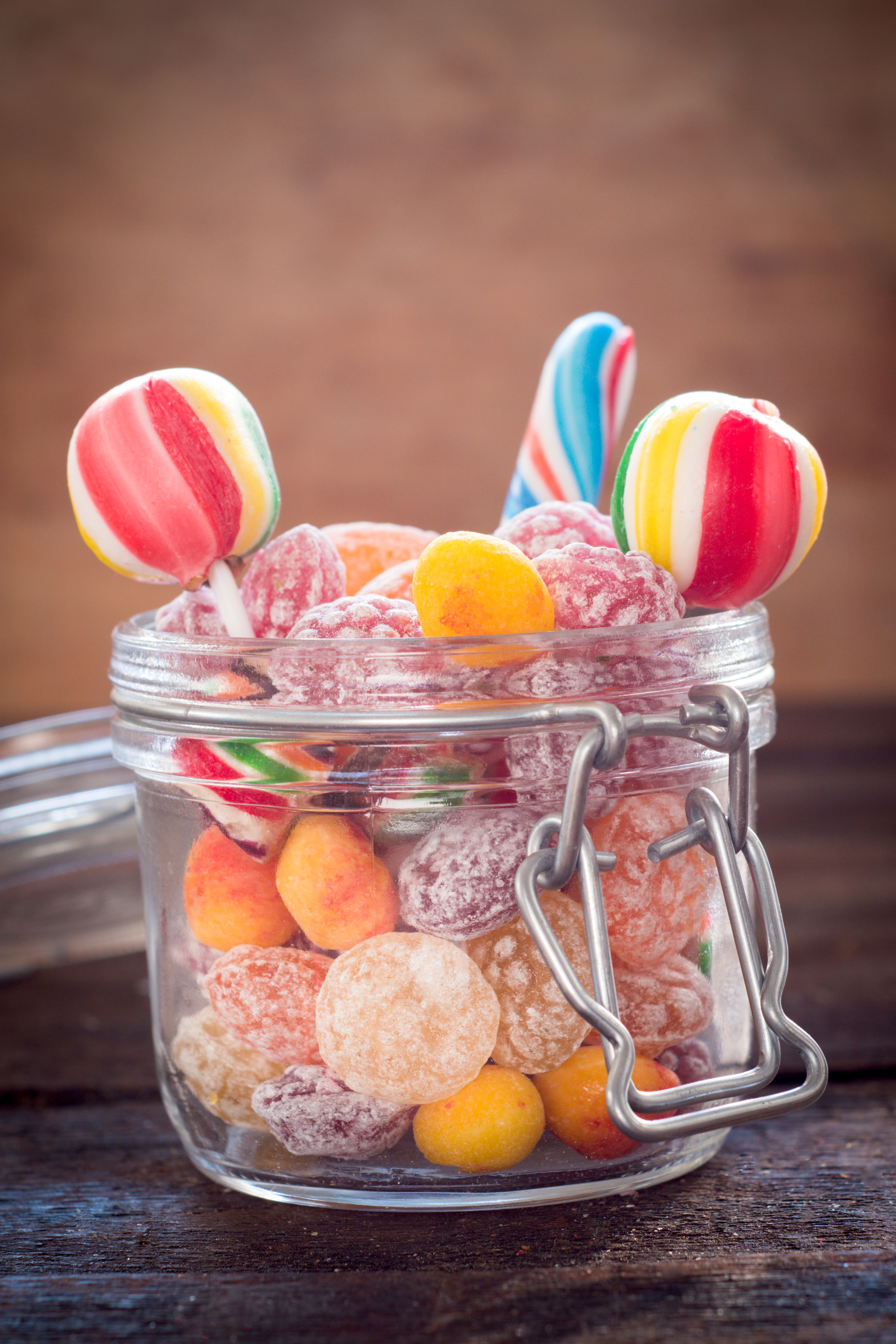 Jar of colorful candies and lollipops HD Phone Wallpaper