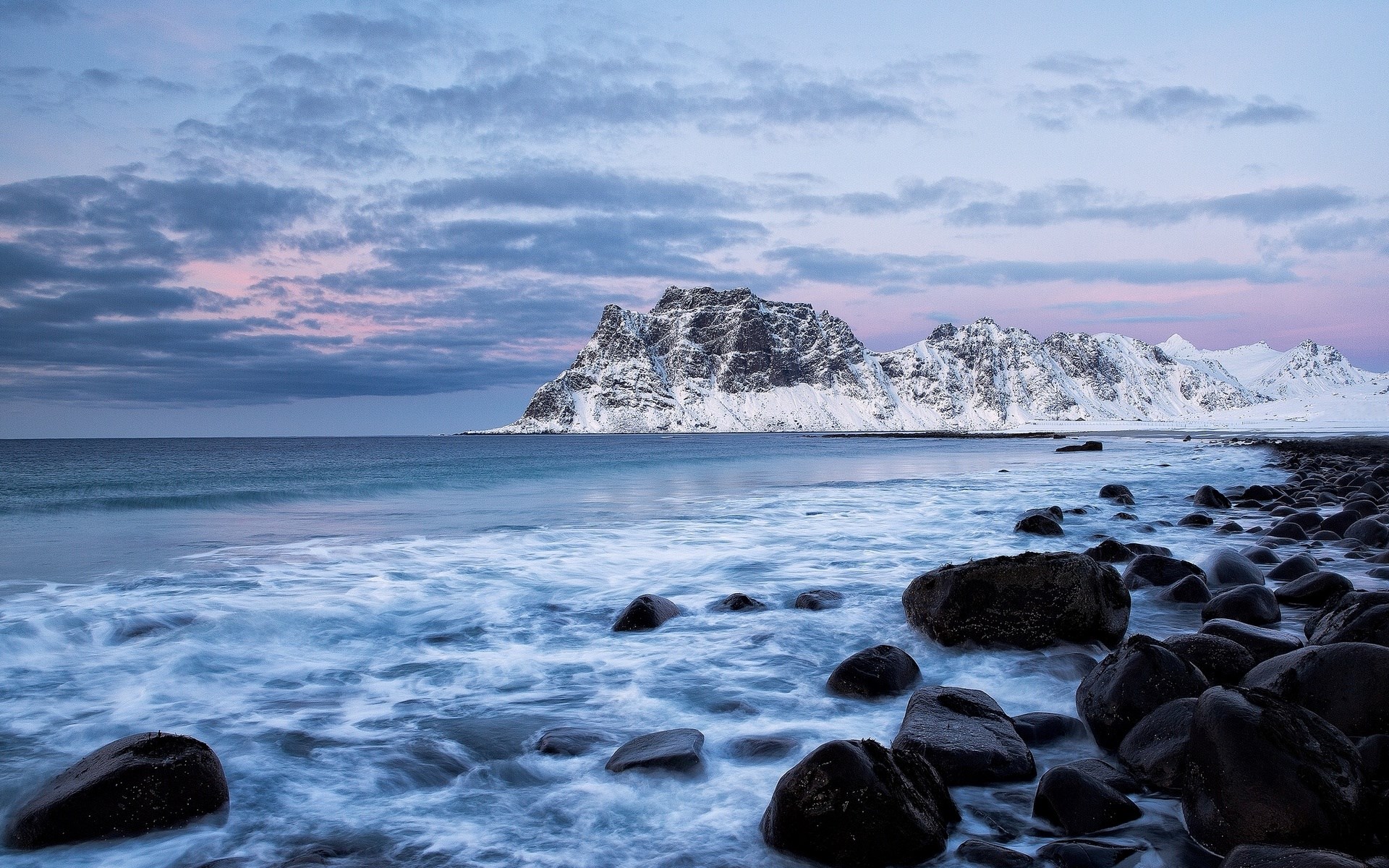 Snowy mountains and rocky beach at dusk HD Wallpaper