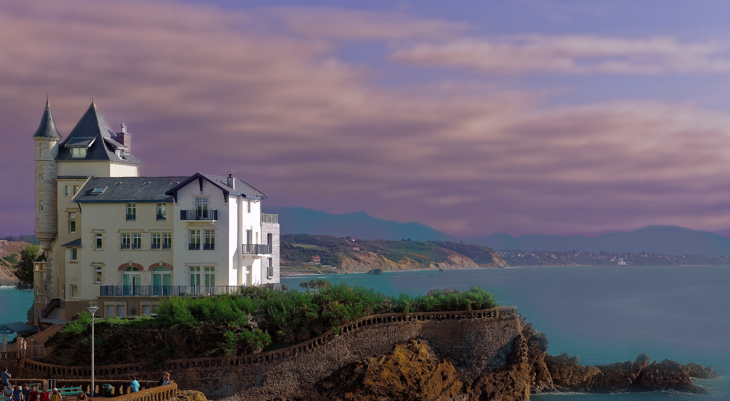 White building with turrets on a cliff overlooking the sea in Biarritz, France HD Wallpaper