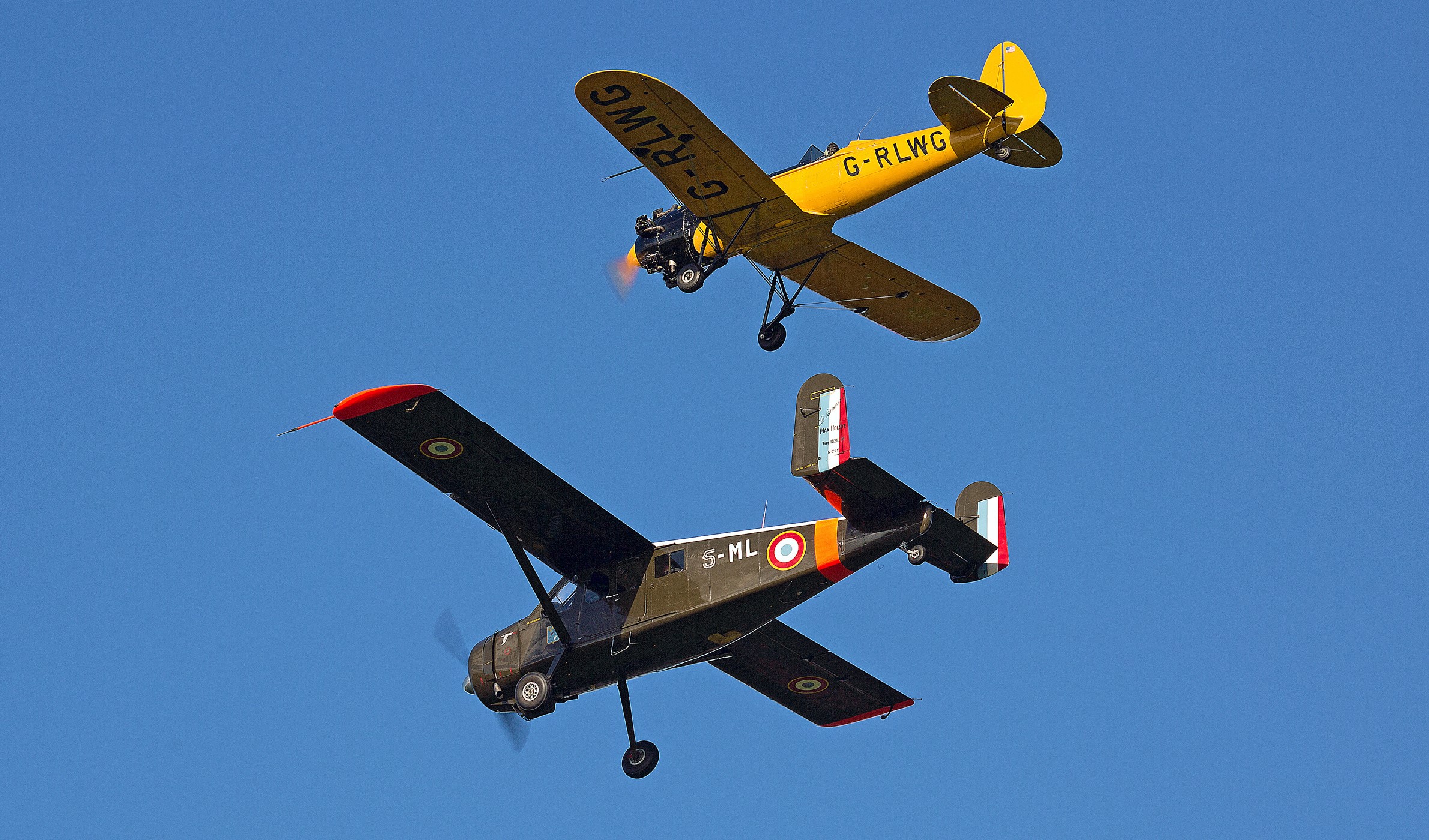 Two vintage airplanes flying in the sky HD Wallpaper