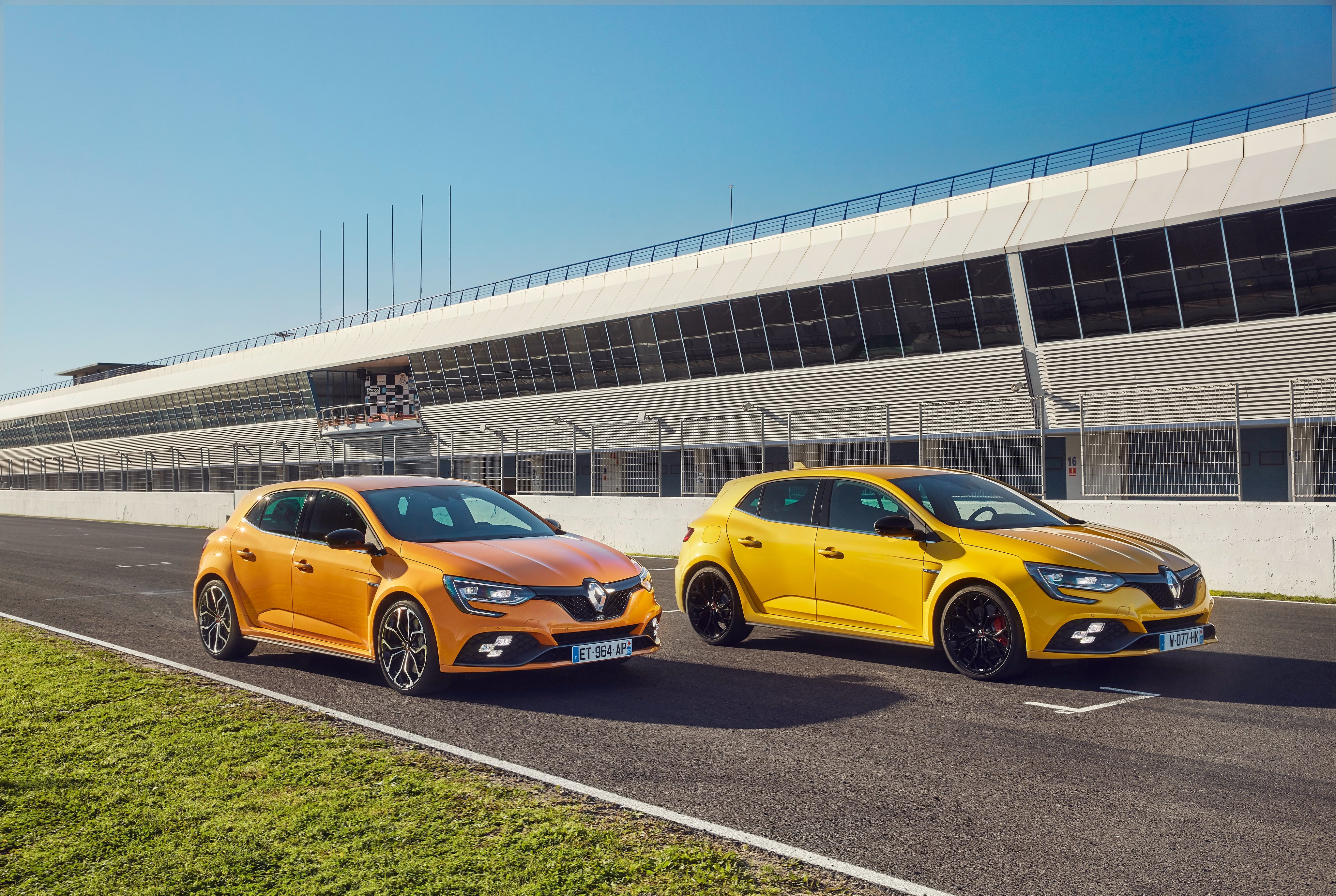 Two Renault Megane RS cars on a racetrack HD Wallpaper