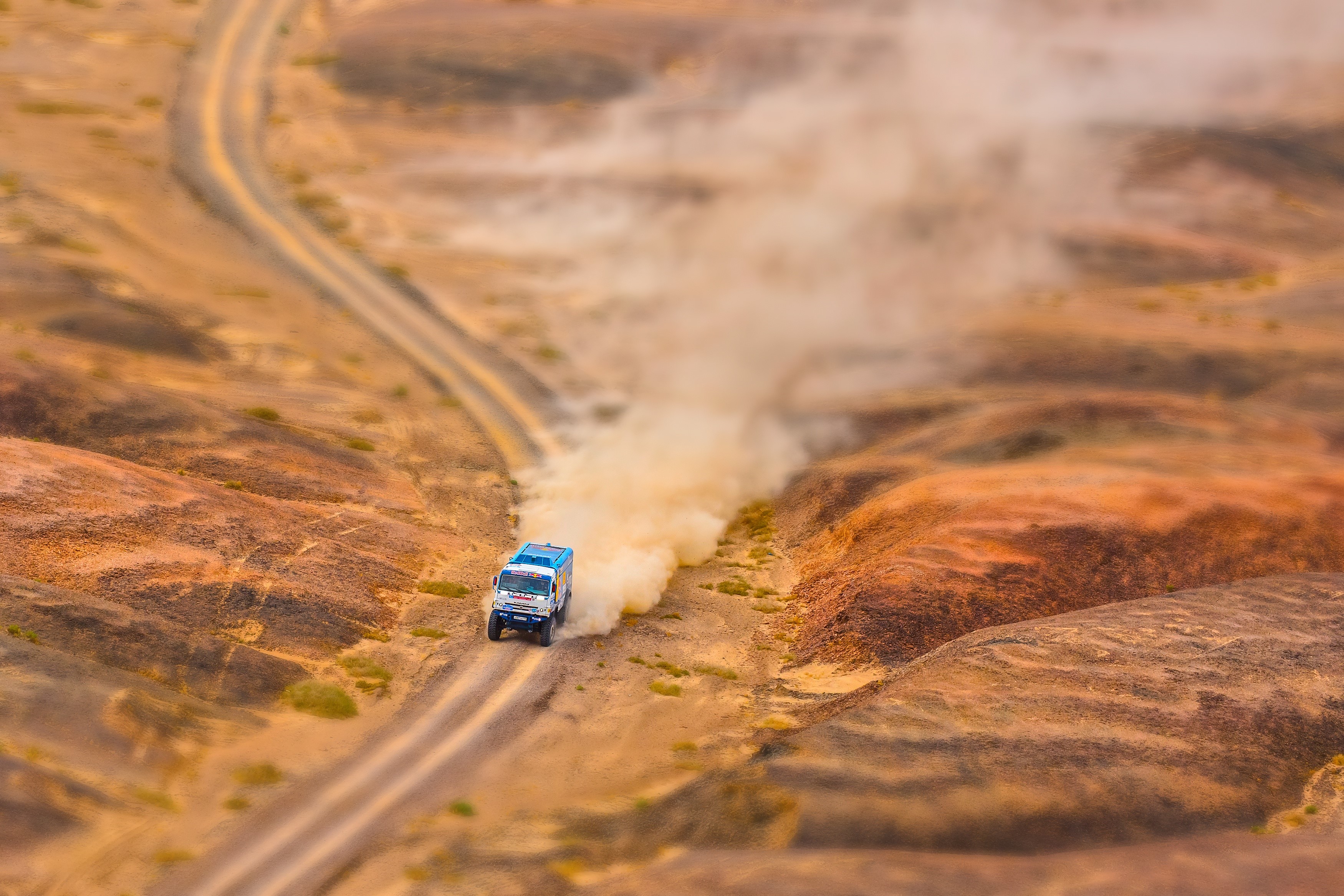 KAMAZ truck in Silk Way rally kicking up dust HD Wallpaper