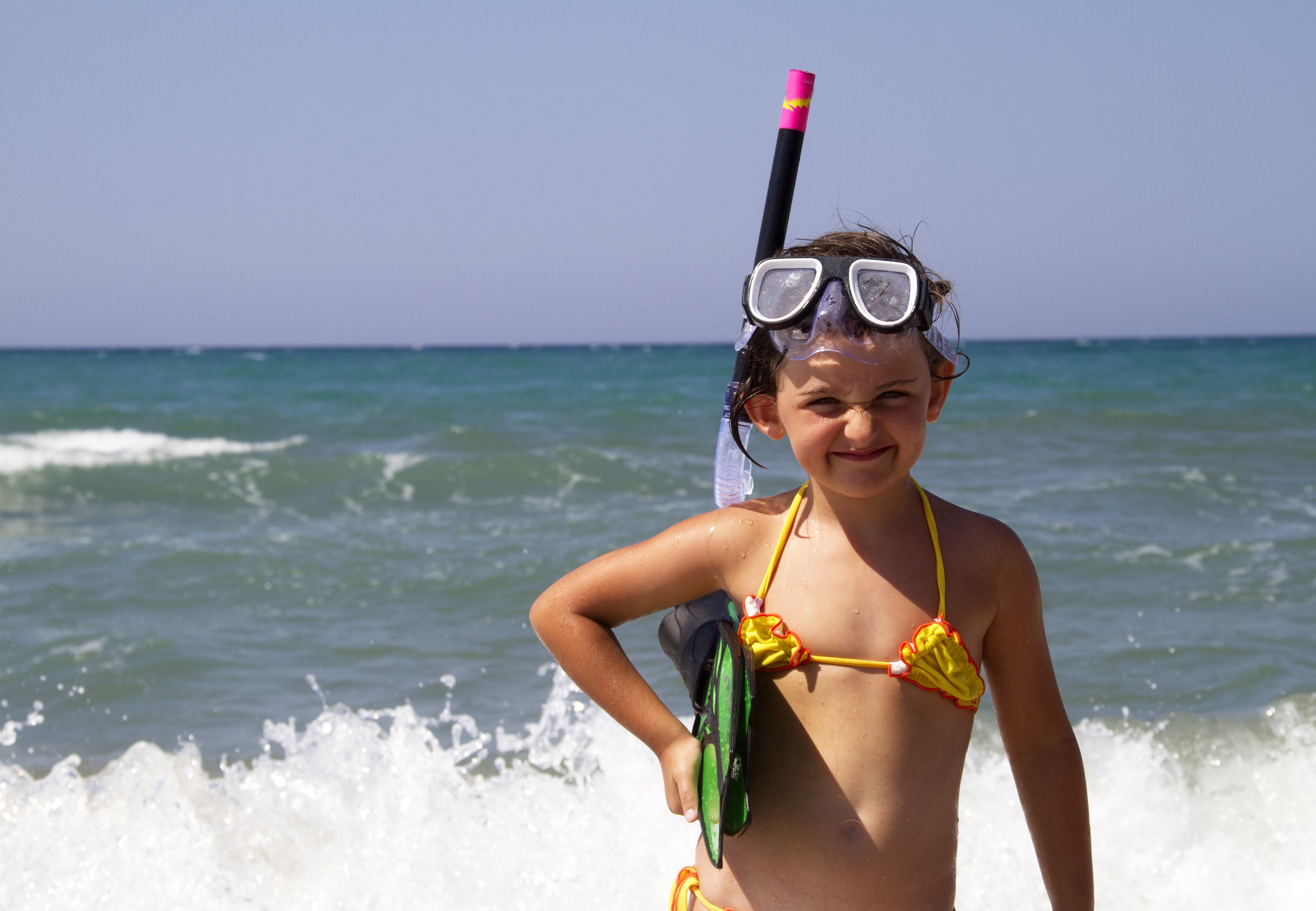 Smiling Little Girl in Snorkel Gear by the Sea 4K HD Wallpaper