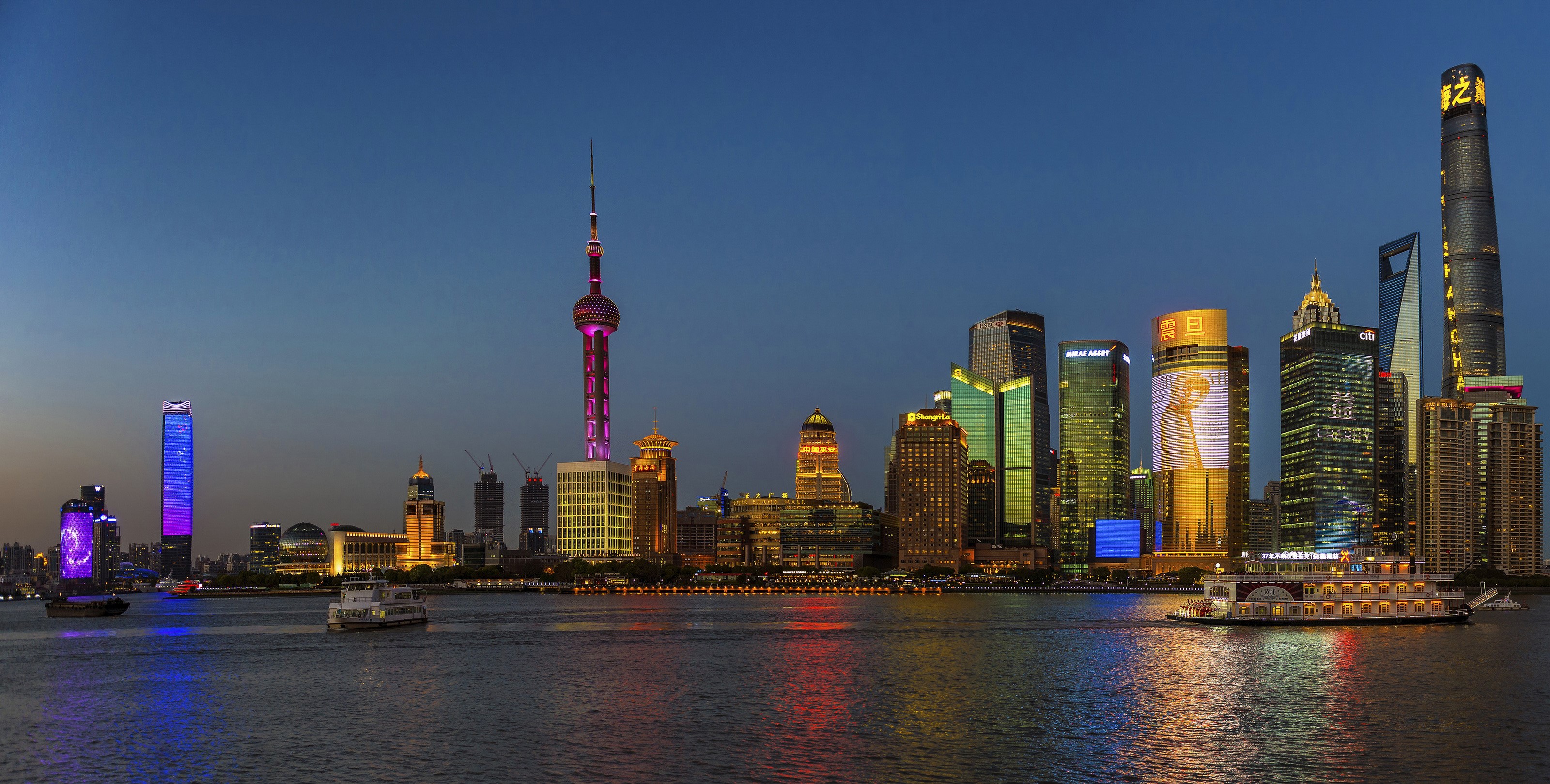 Shanghai skyline at dusk with boats on the river HD Wallpaper